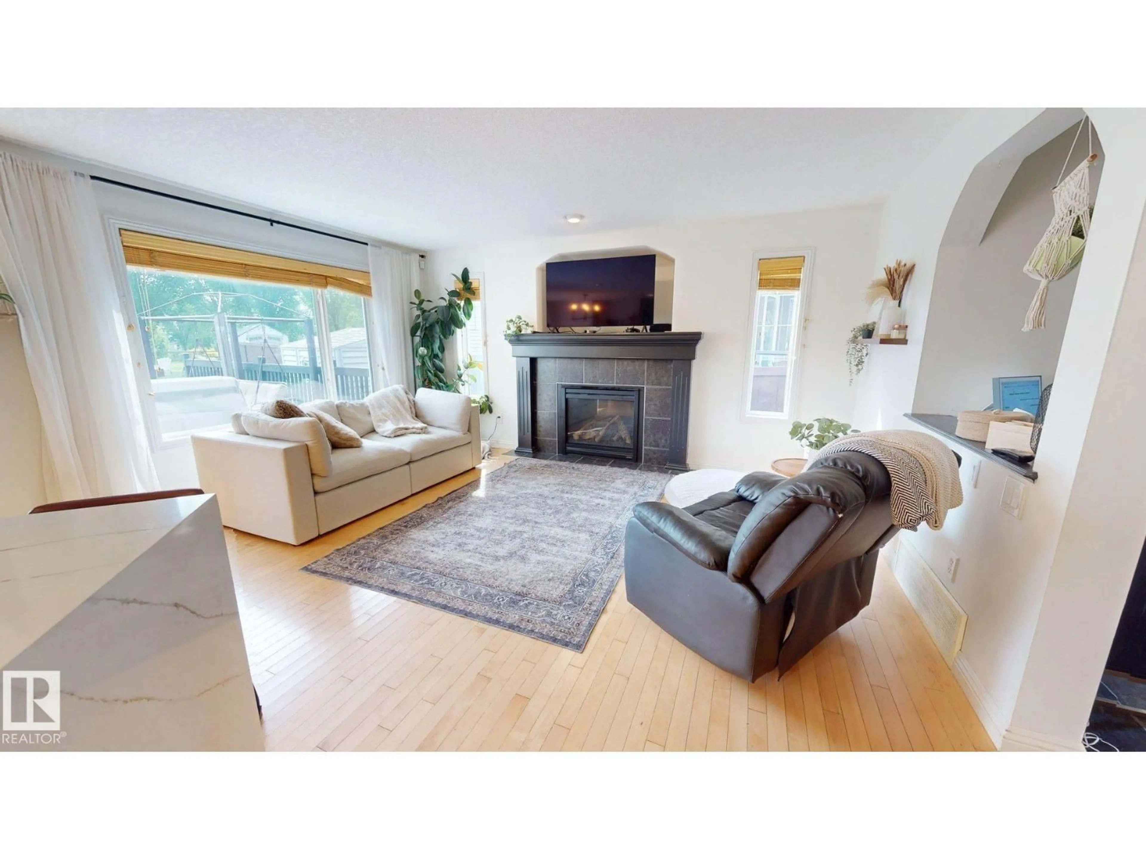 Living room with furniture, wood/laminate floor for 1303 117ST SW, Edmonton Alberta T6W0E6