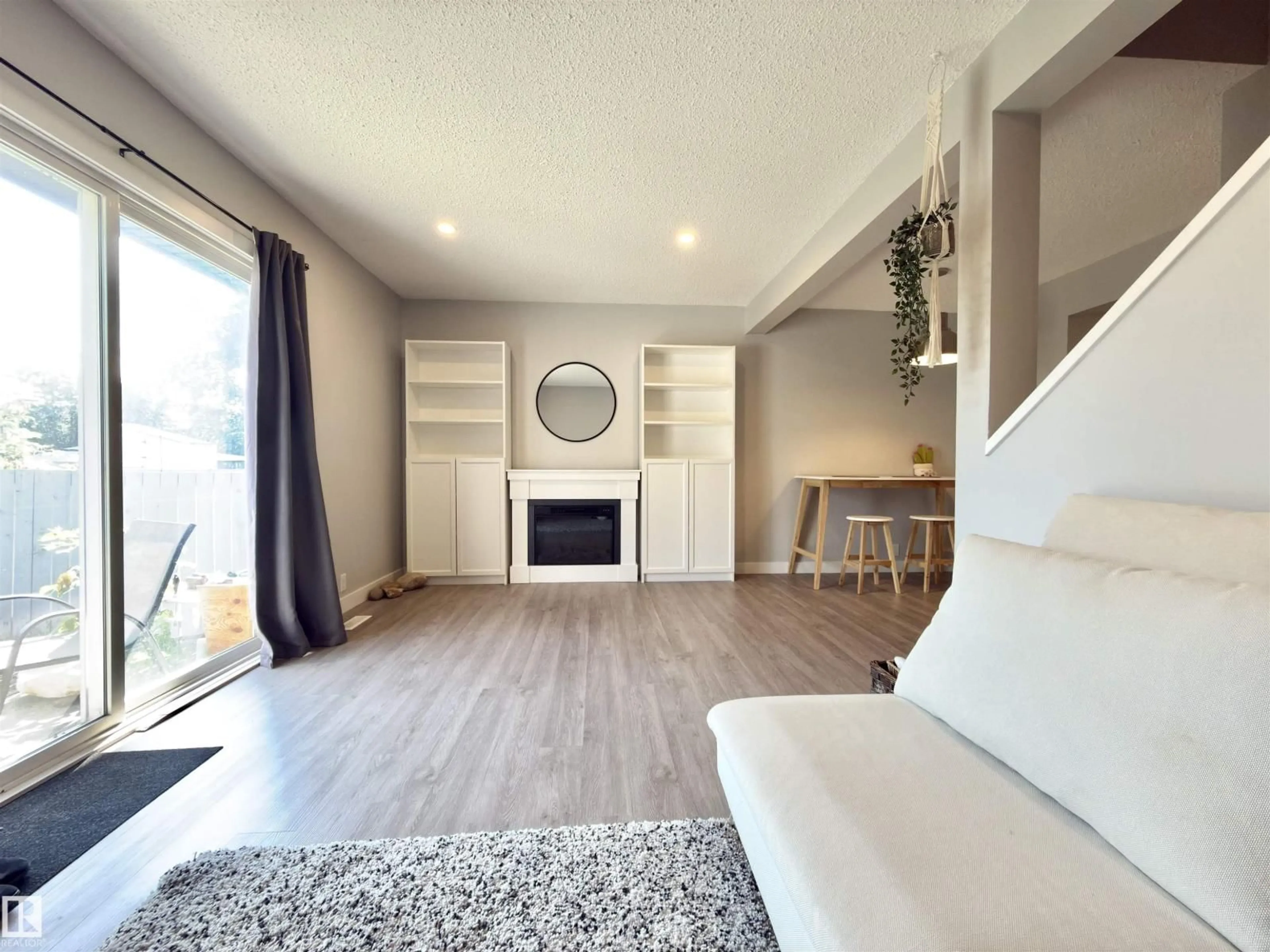 Living room with furniture, wood/laminate floor for 13 - 18010 98 AV, Edmonton Alberta T5T3H6