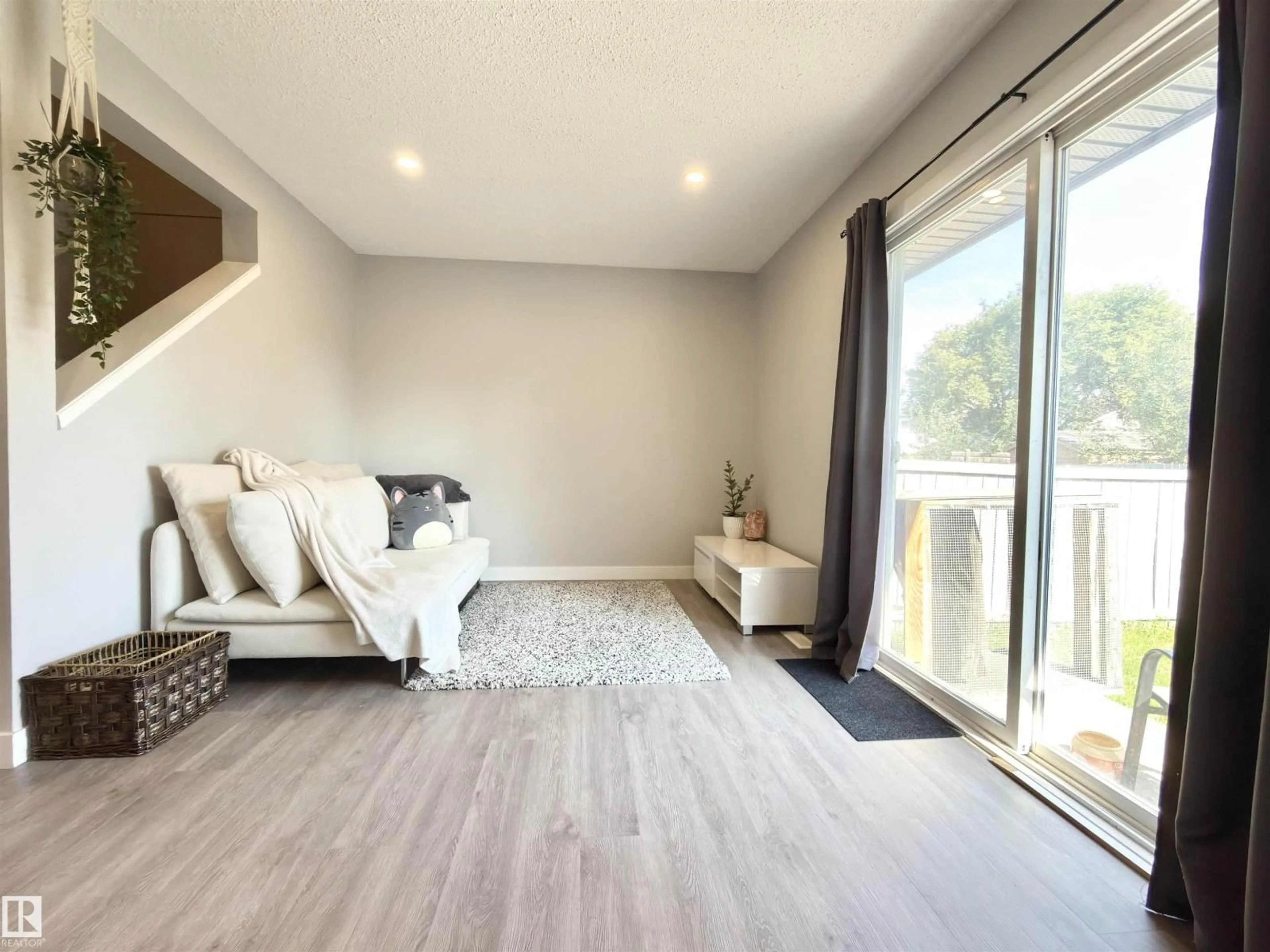 Living room with furniture, wood/laminate floor for 13 - 18010 98 AV, Edmonton Alberta T5T3H6