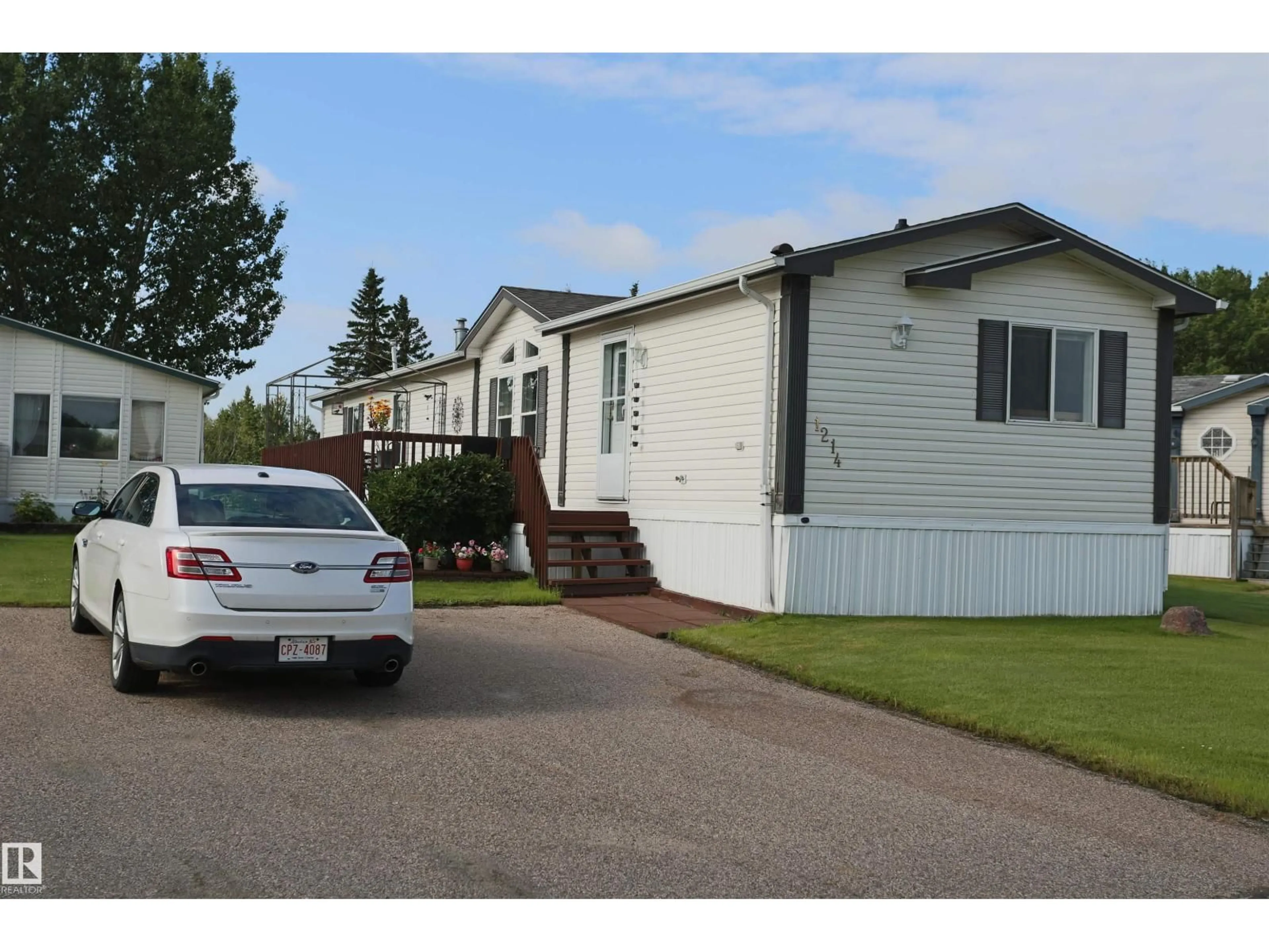 Home with vinyl exterior material, street for 53222 - 1214 RR 272, Rural Parkland County Alberta T7X4K4