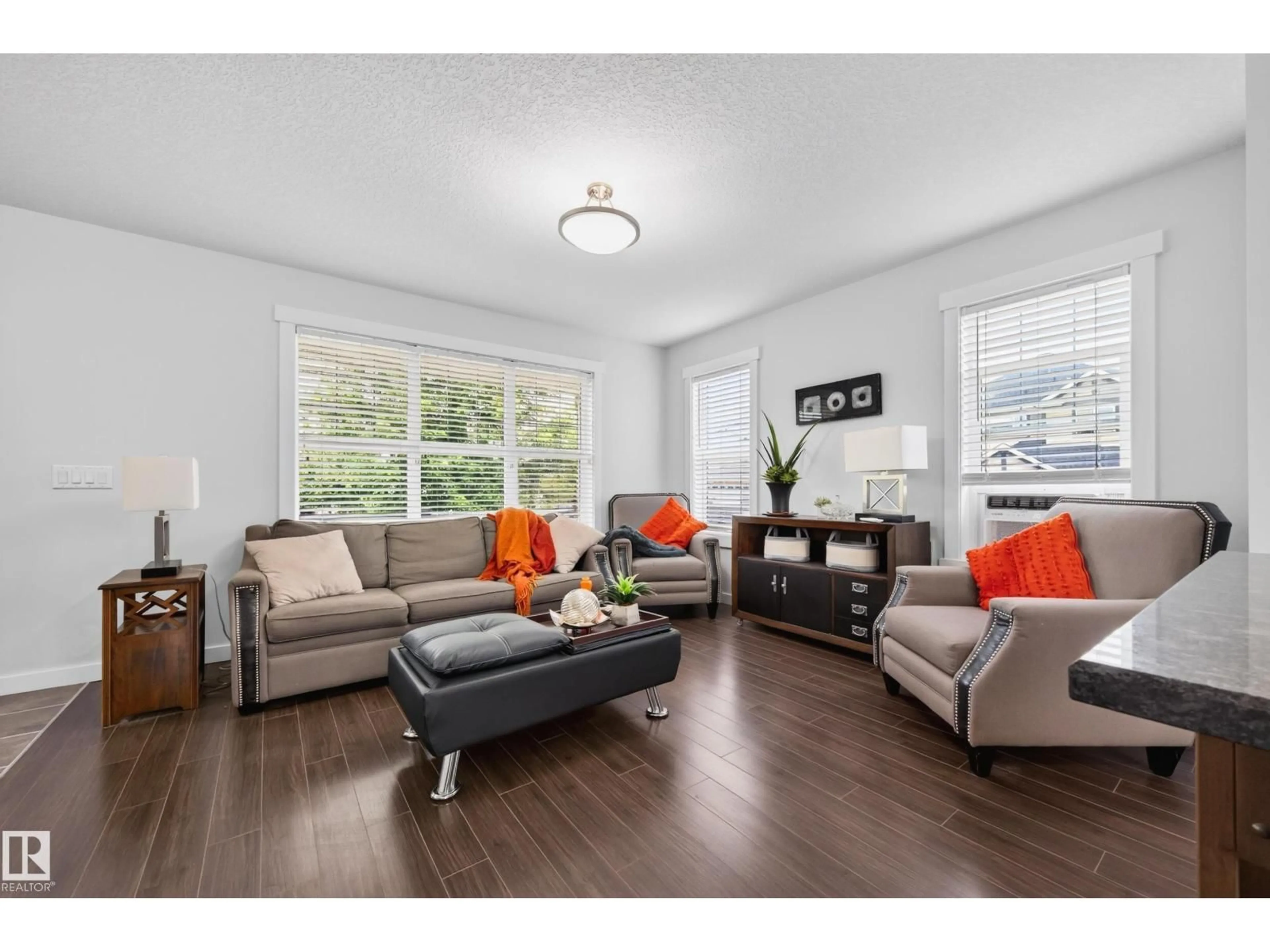 Living room with furniture, wood/laminate floor for SW - 1007 162 ST, Edmonton Alberta T6W2G9