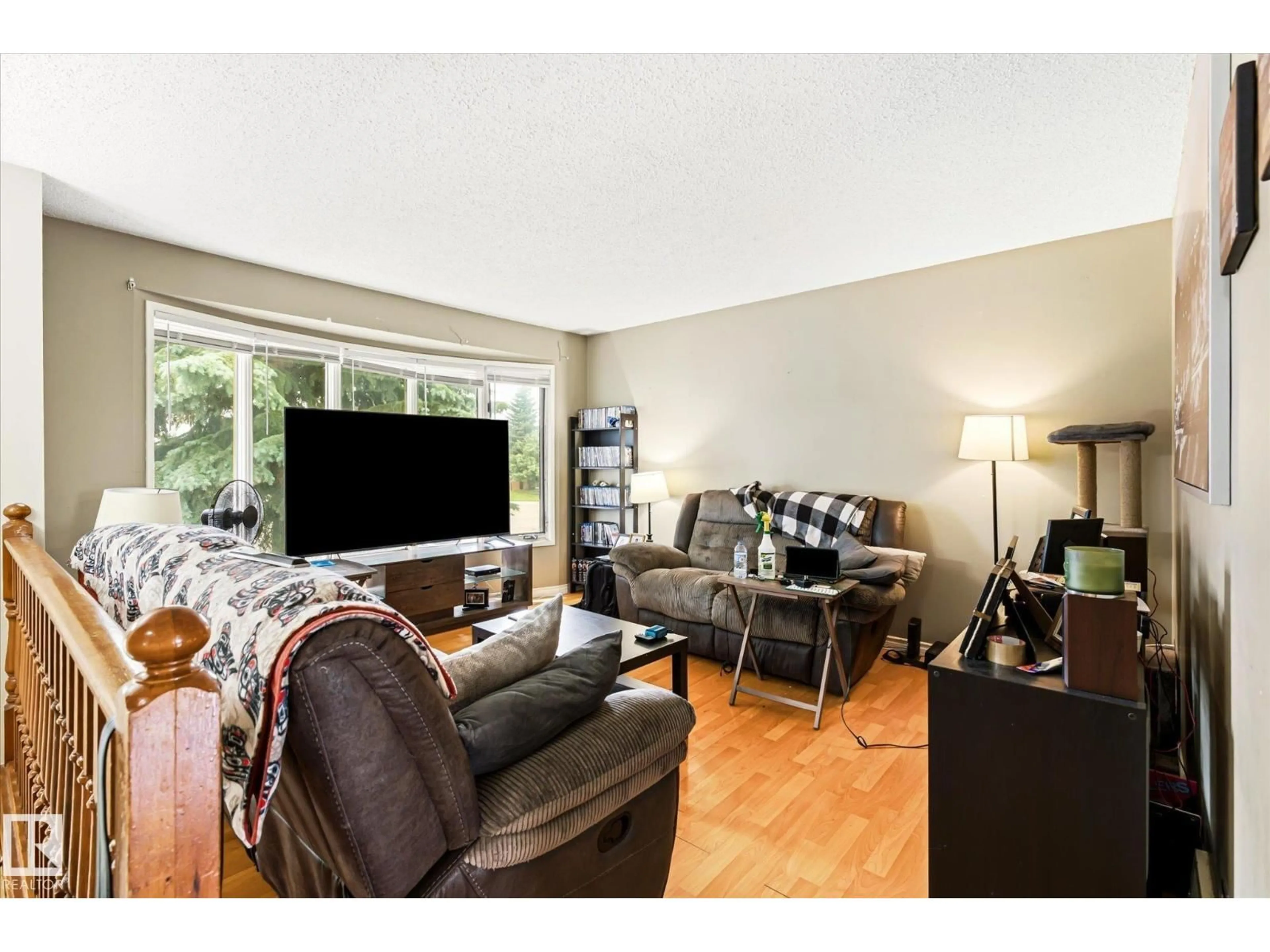 Living room with furniture, wood/laminate floor for NW - 12435 46 ST, Edmonton Alberta T5W5E2