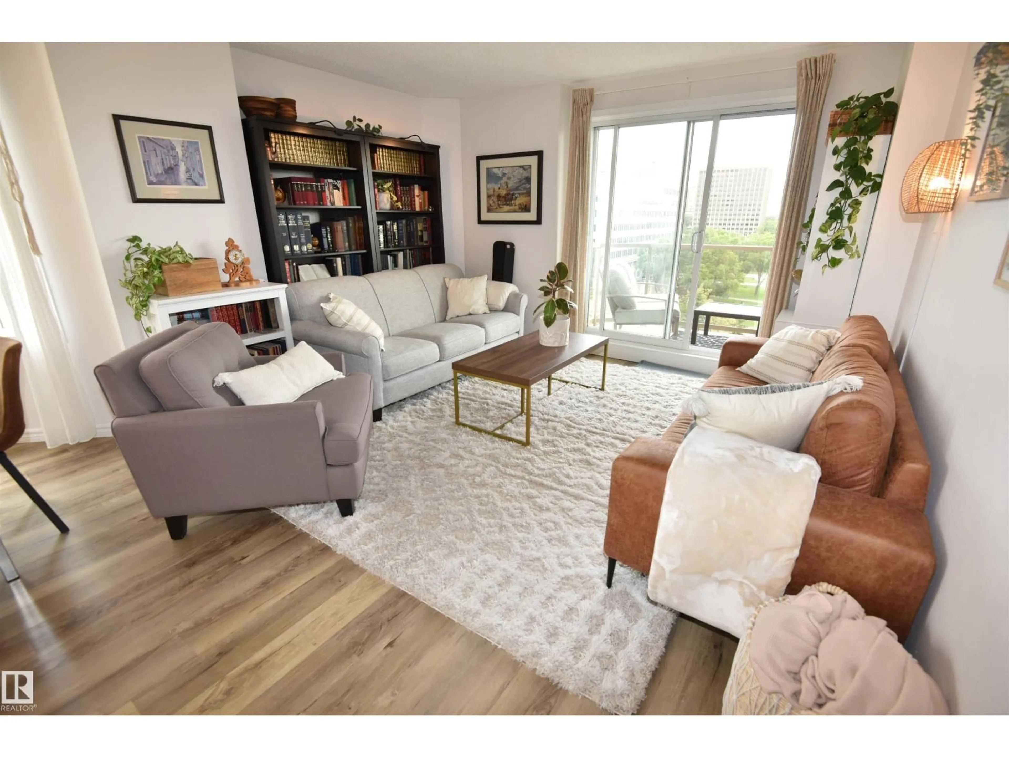 Living room with furniture, wood/laminate floor for 701 - 9741 110 ST, Edmonton Alberta T5K2Y8
