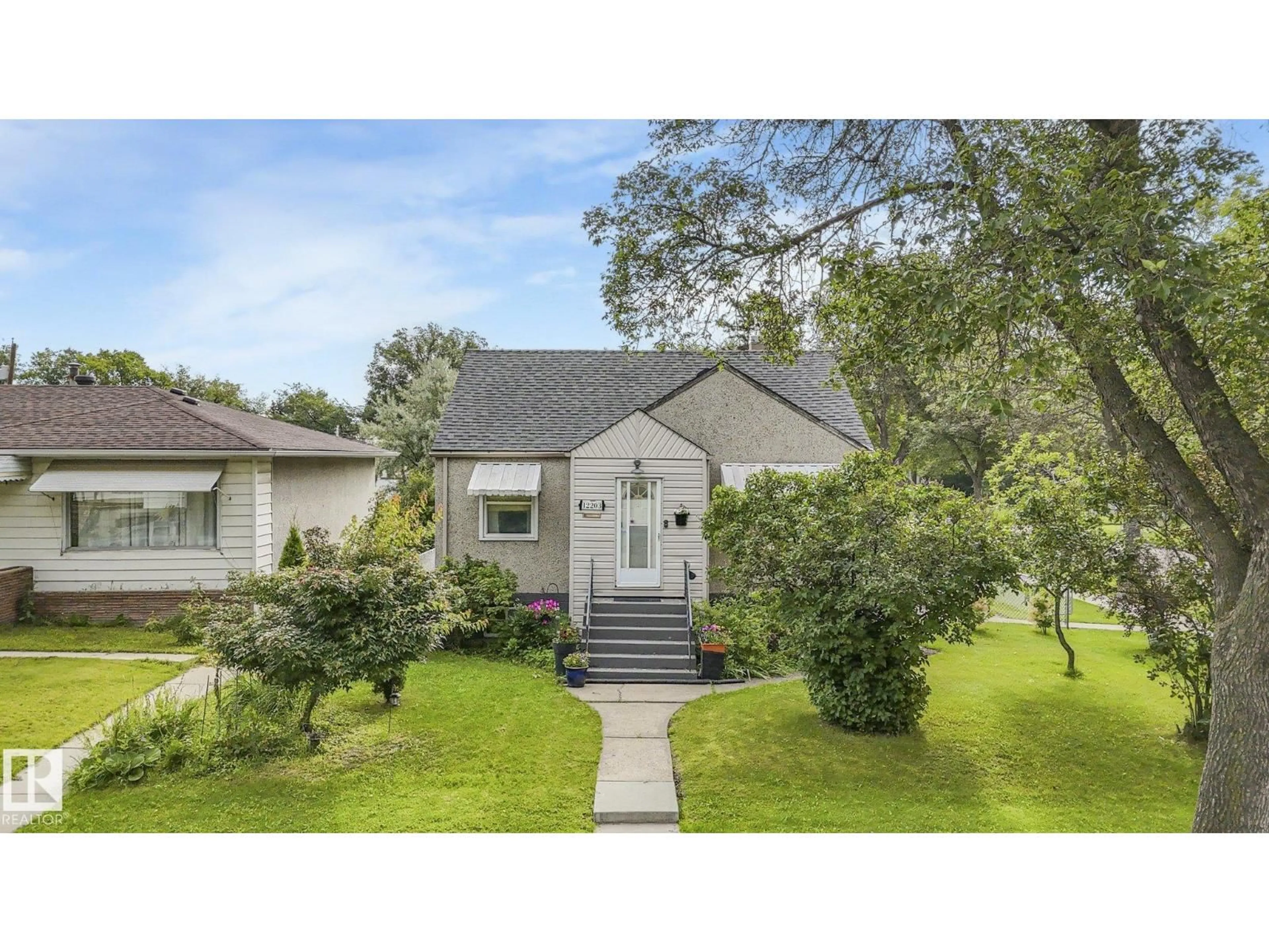 Home with vinyl exterior material, street for 12203 126 ST, Edmonton Alberta T5L0W9