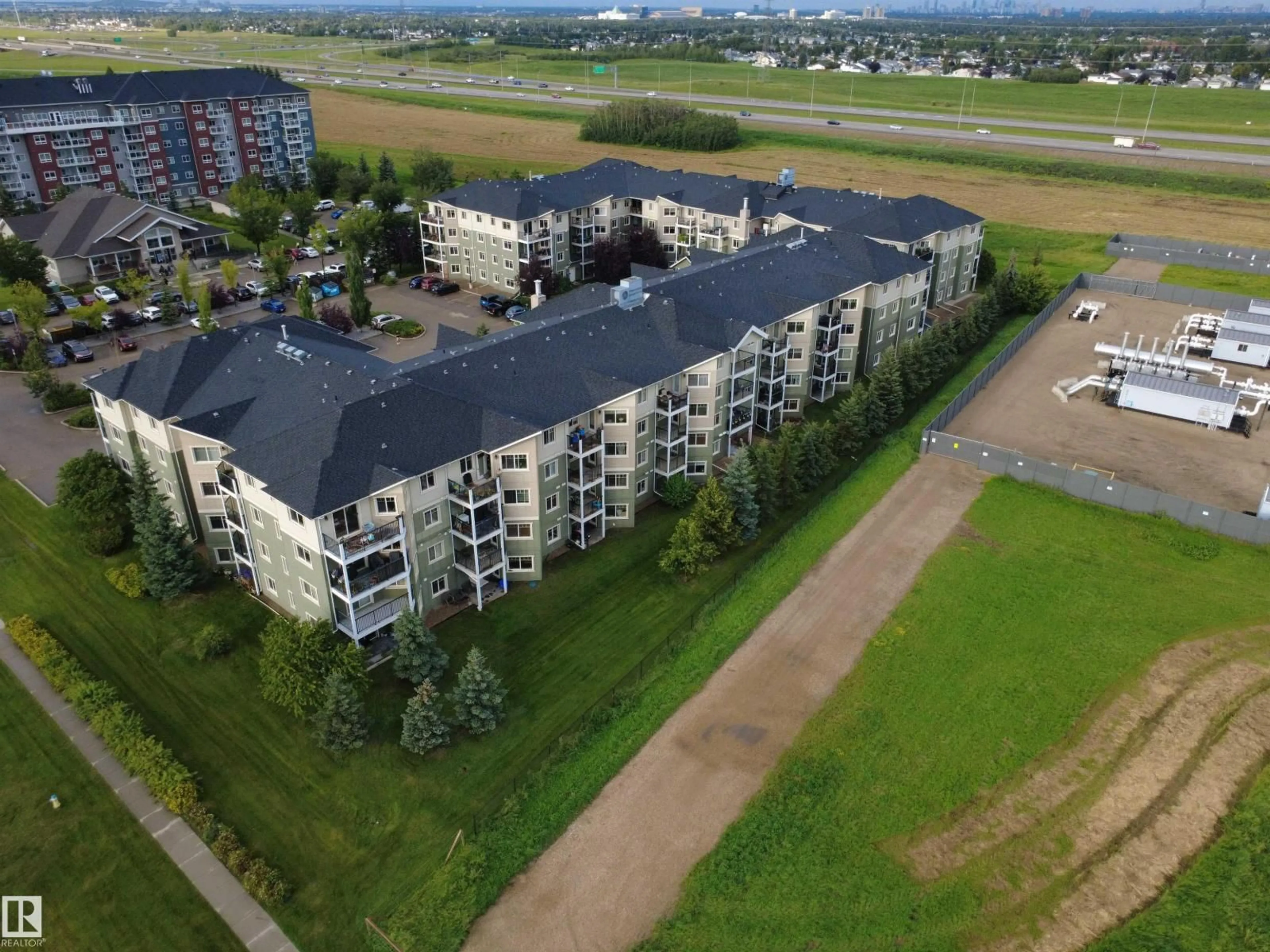 A pic from outside/outdoor area/front of a property/back of a property/a pic from drone, building for 208 - 6921 199 ST, Edmonton Alberta T5T3X7