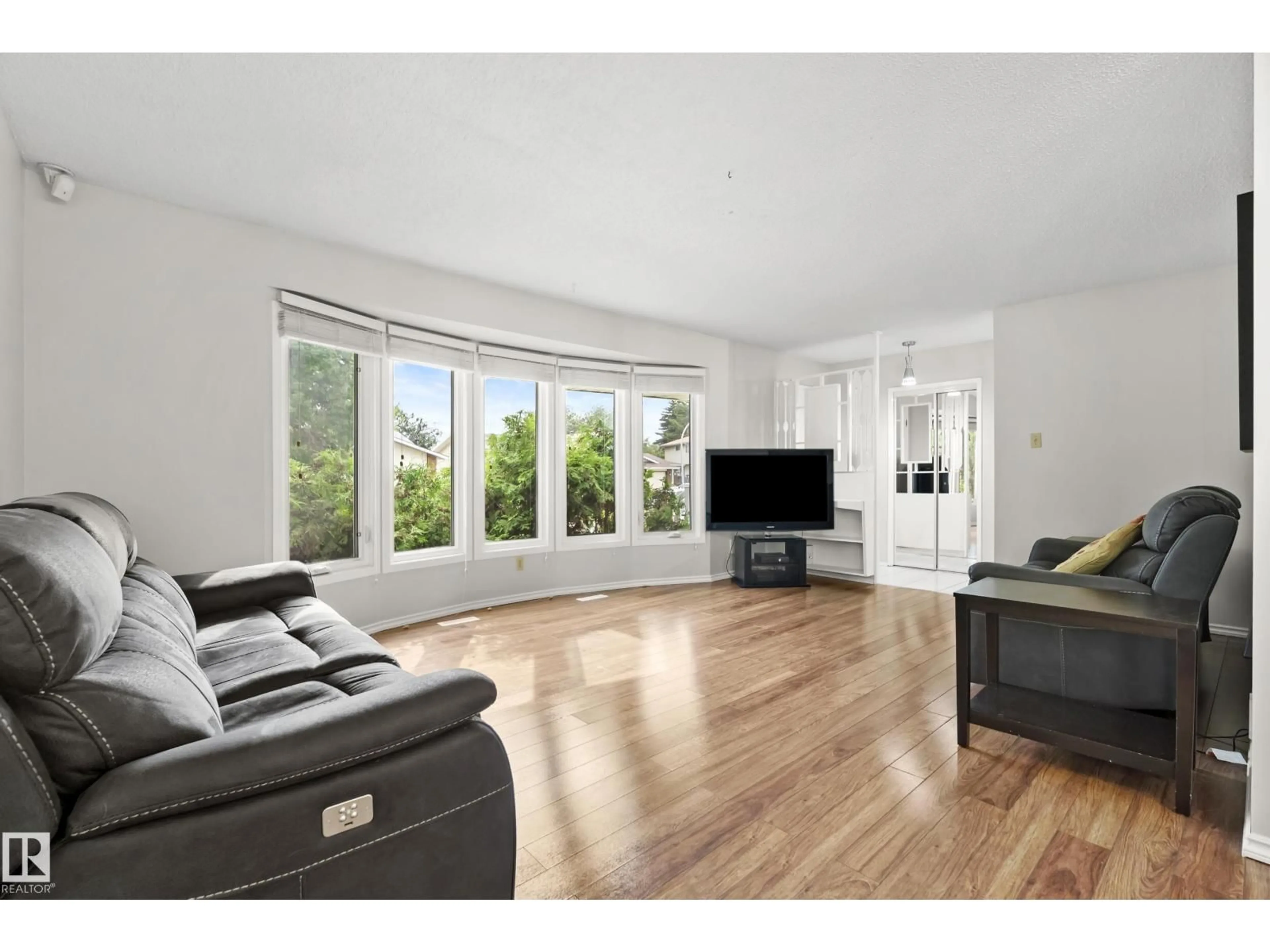 Living room with furniture, wood/laminate floor for NW - 17312 105 ST, Edmonton Alberta T5X3H4