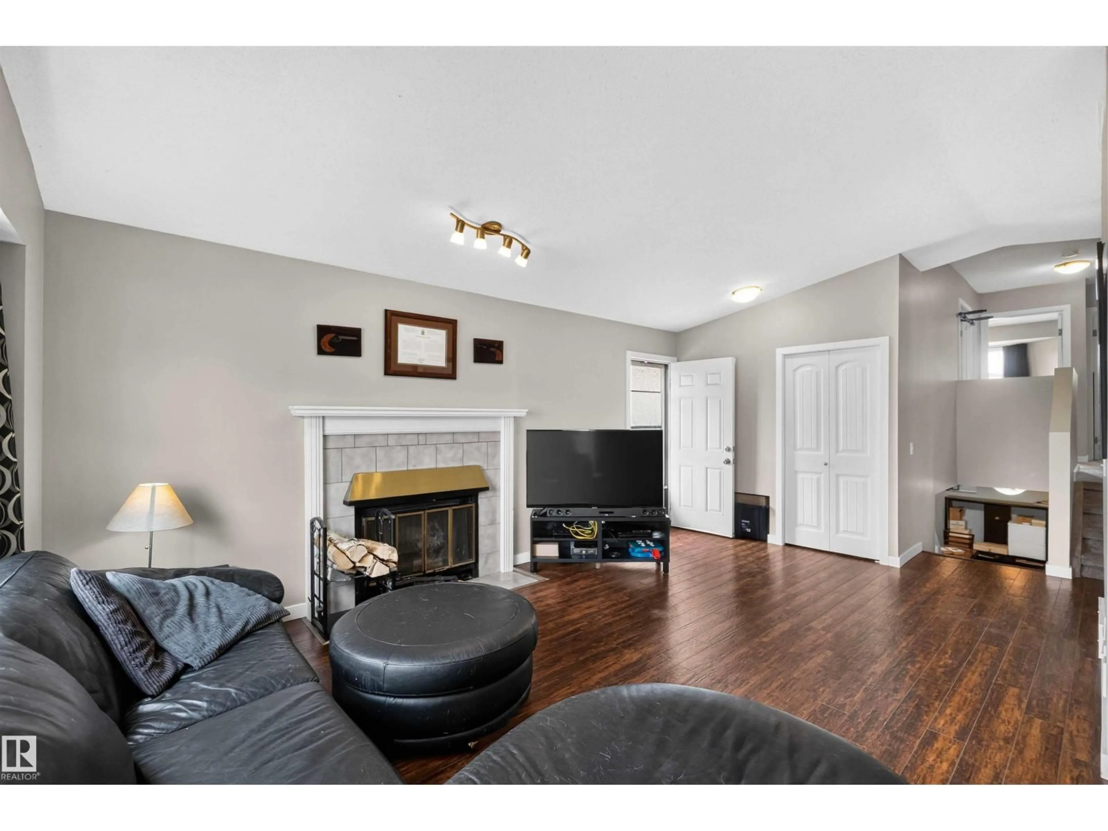Living room with furniture, wood/laminate floor for 17132 96 ST, Edmonton Alberta T5Z1Z6
