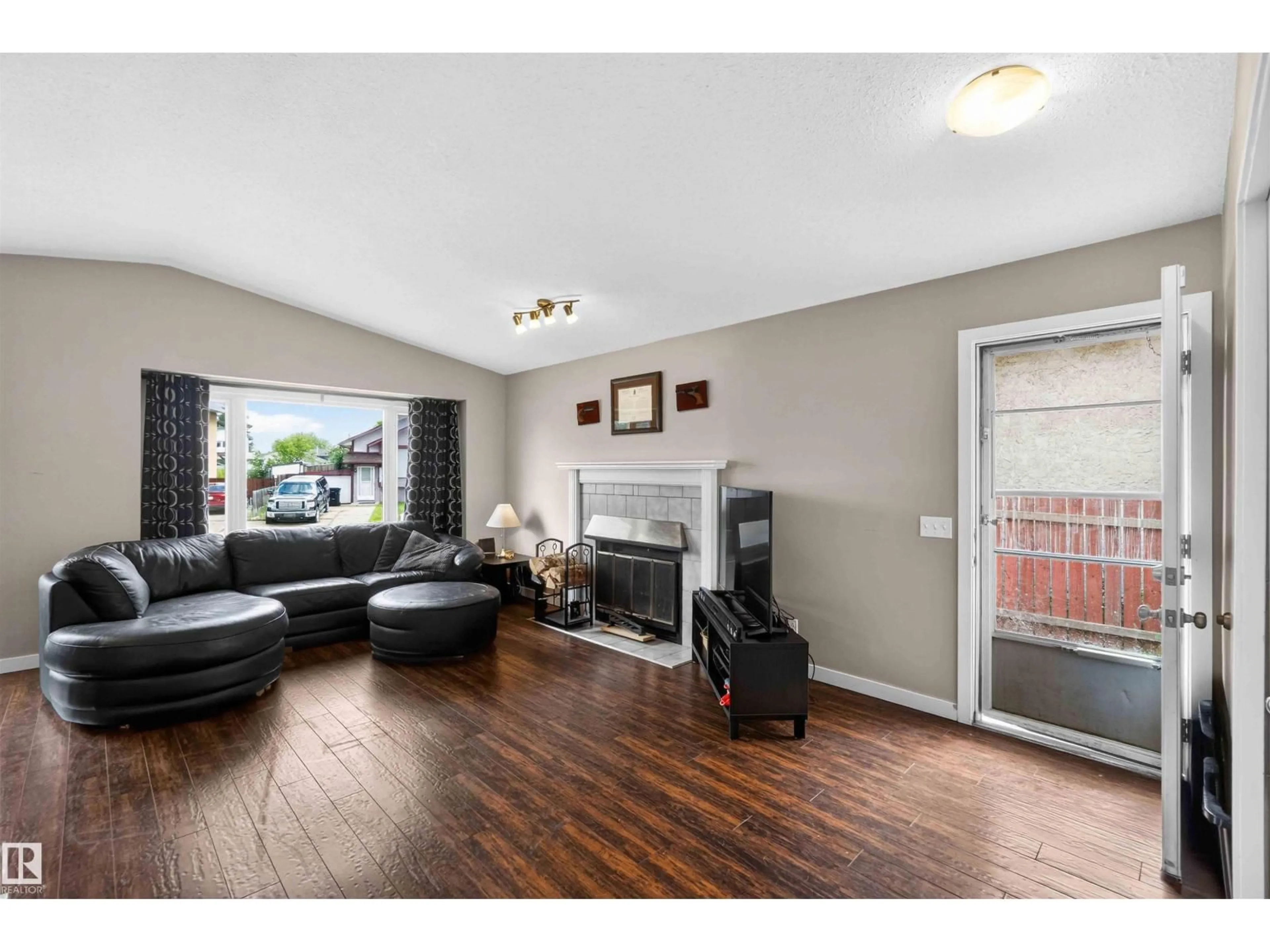 Living room with furniture, wood/laminate floor for 17132 96 ST, Edmonton Alberta T5Z1Z6