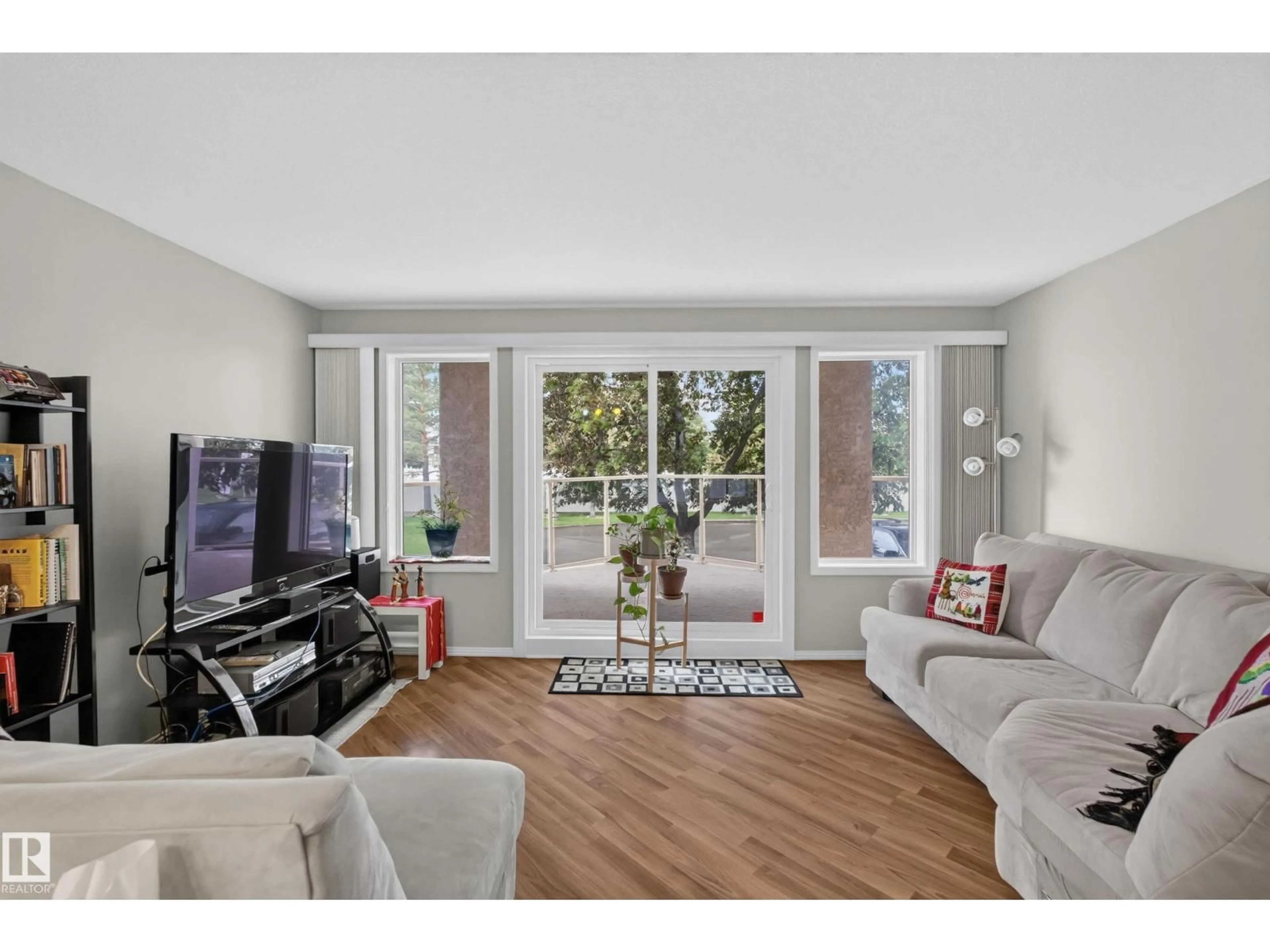 Living room with furniture, wood/laminate floor for #105 - 10421 42 AV, Edmonton Alberta T6A7C8
