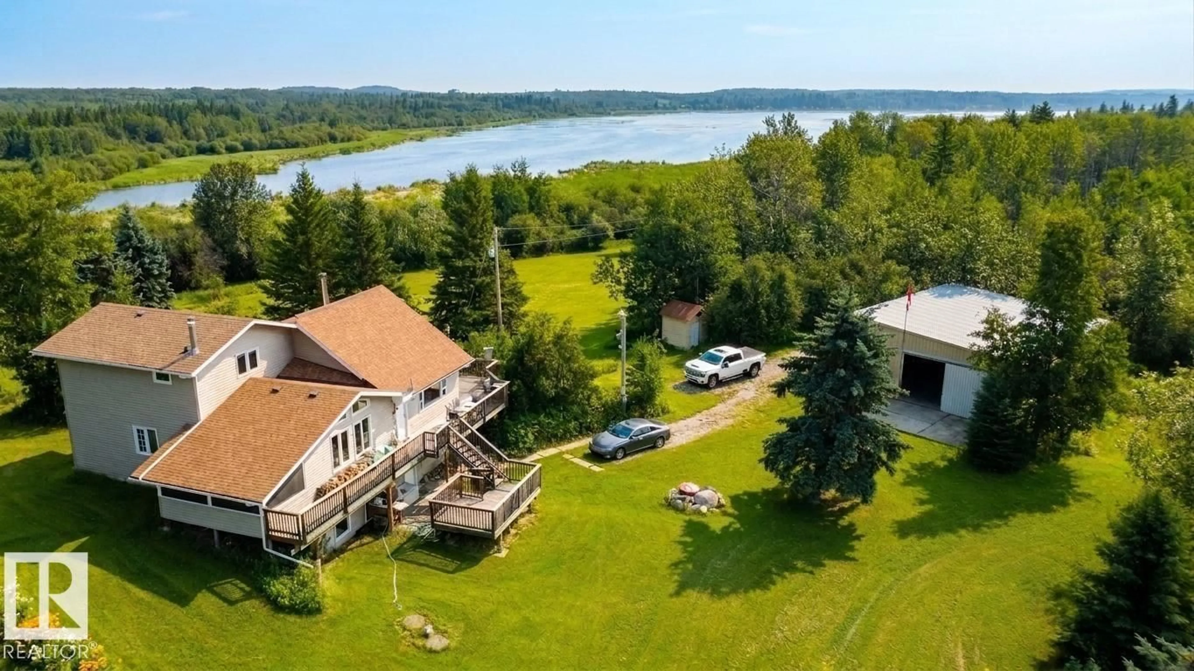 A pic from outside/outdoor area/front of a property/back of a property/a pic from drone, water/lake/river/ocean view for 56019 RGE ROAD 13, Rural Lac Ste. Anne County Alberta T0E1V0