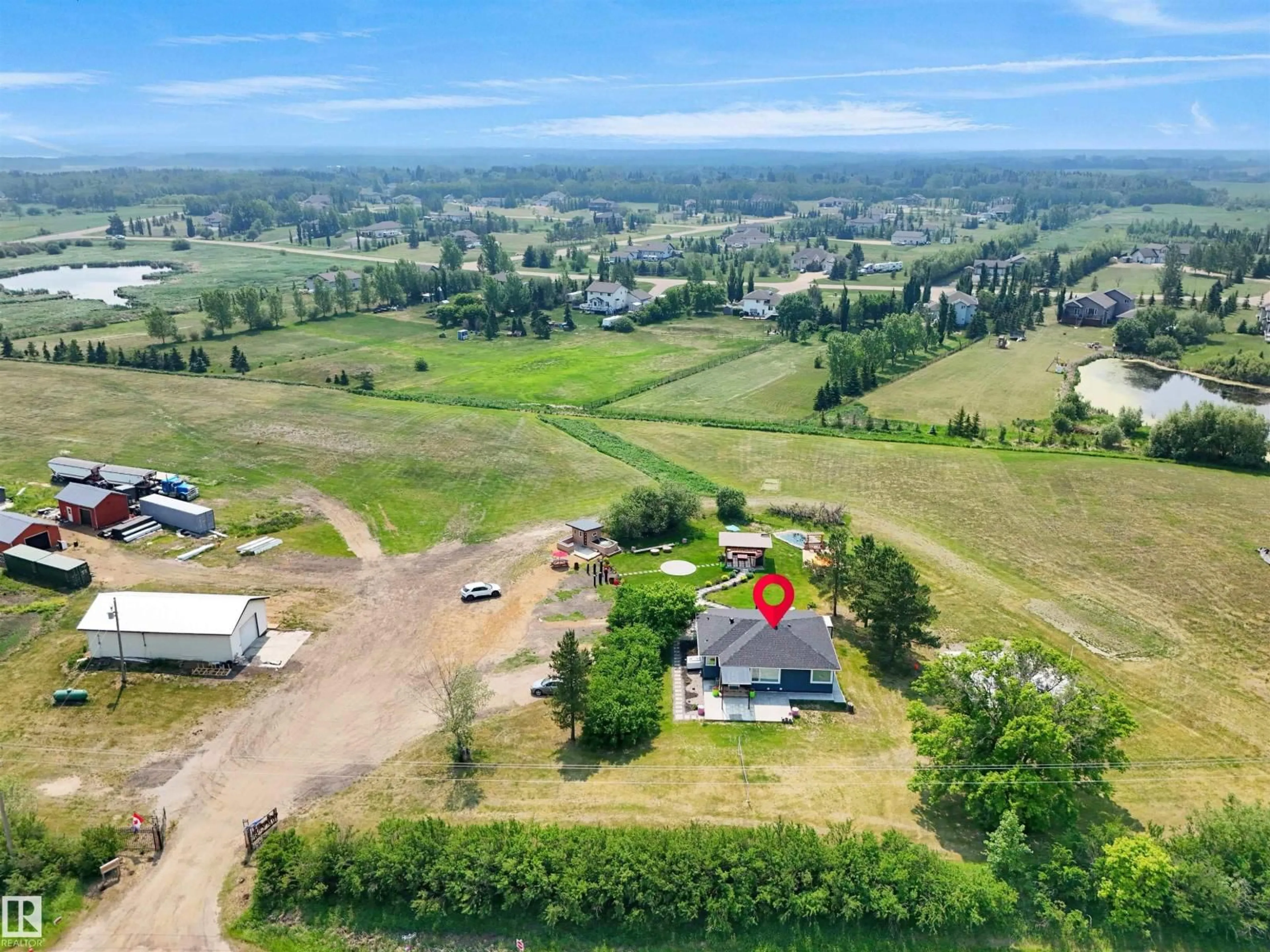 A pic from outside/outdoor area/front of a property/back of a property/a pic from drone, mountain view for NE - 22517 WYE RD, Rural Strathcona County Alberta T8C1H9