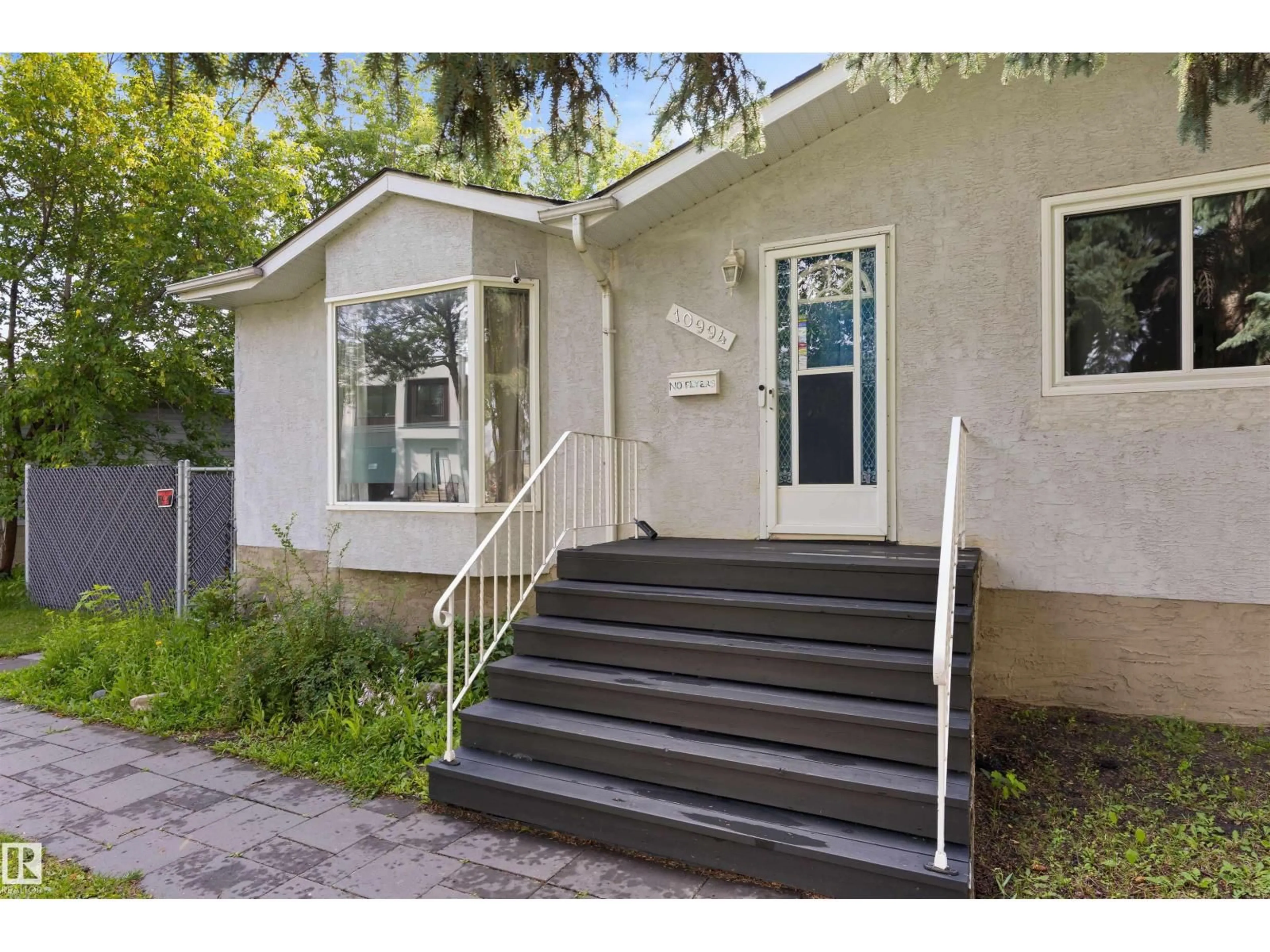 Home with vinyl exterior material, street for NW - 10994 135 ST, Edmonton Alberta T5M1K2