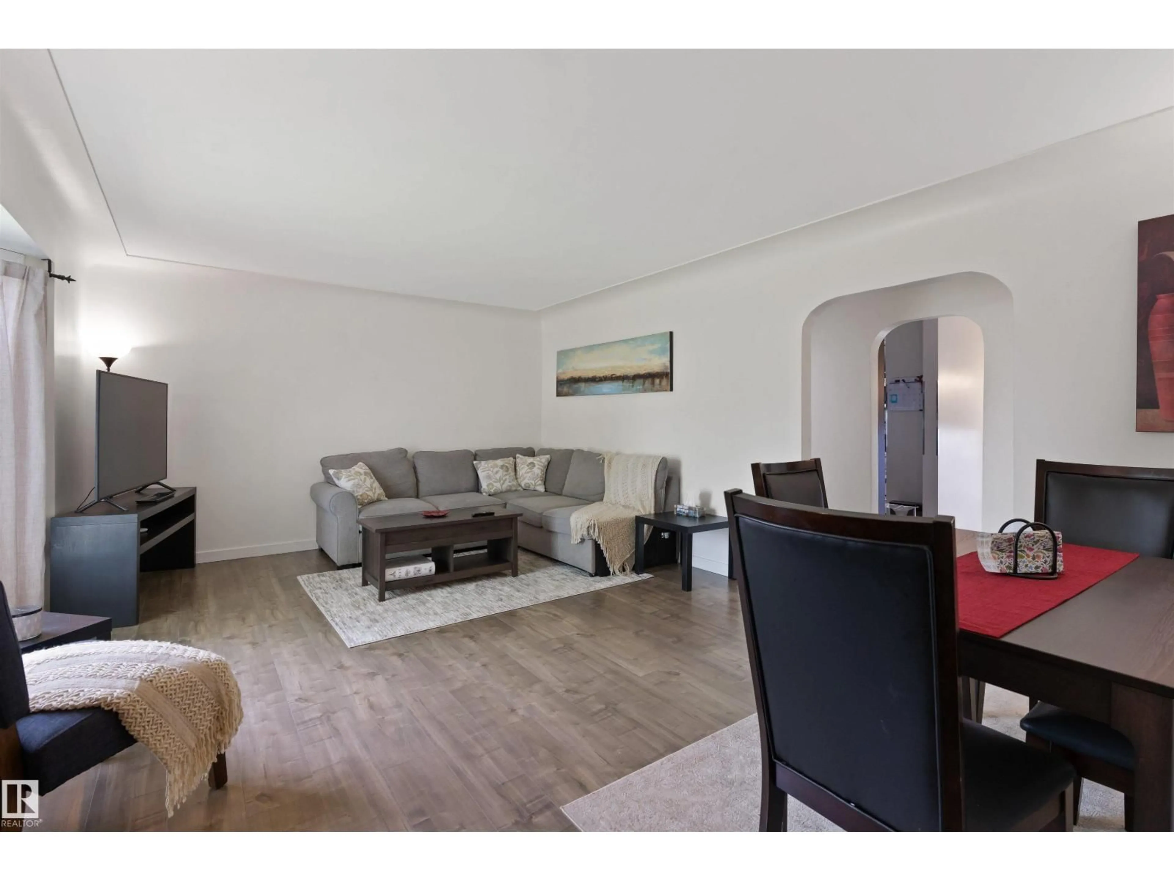 Living room with furniture, wood/laminate floor for NW - 10994 135 ST, Edmonton Alberta T5M1K2