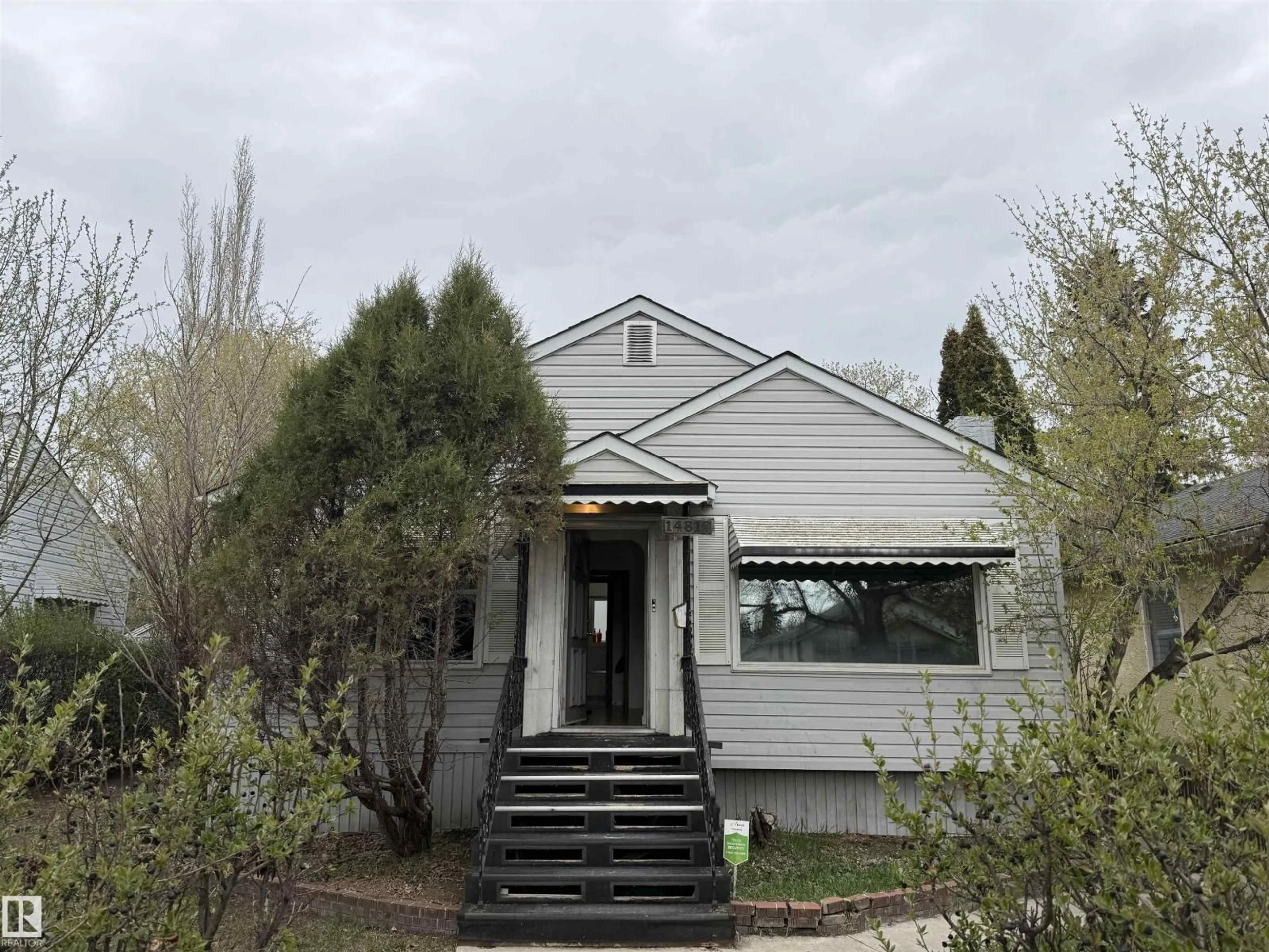 Home with vinyl exterior material, street for 14810 104 AV, Edmonton Alberta T5N0X7