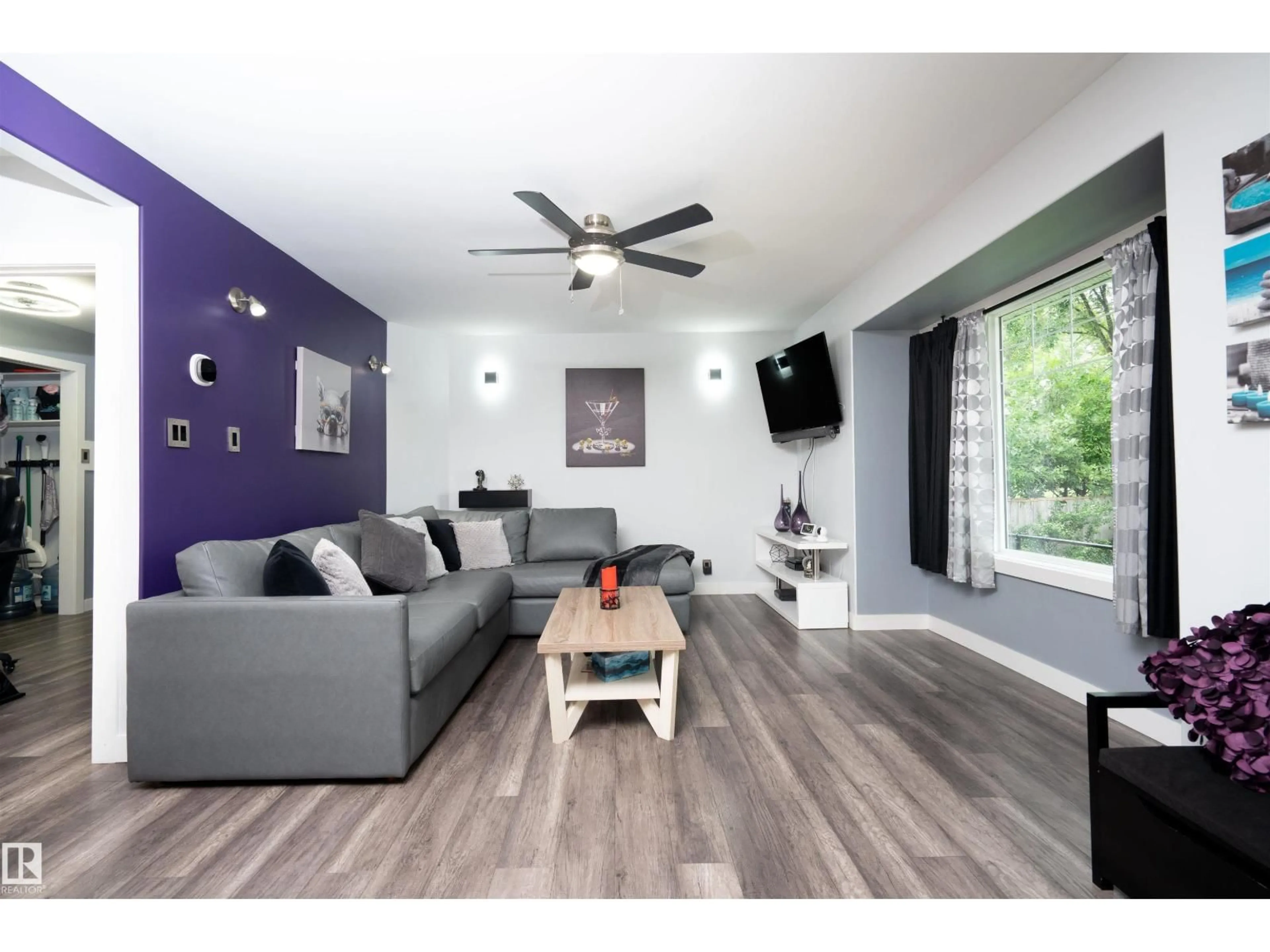 Living room with furniture, wood/laminate floor for 6111 119 AV, Edmonton Alberta T5W1J7