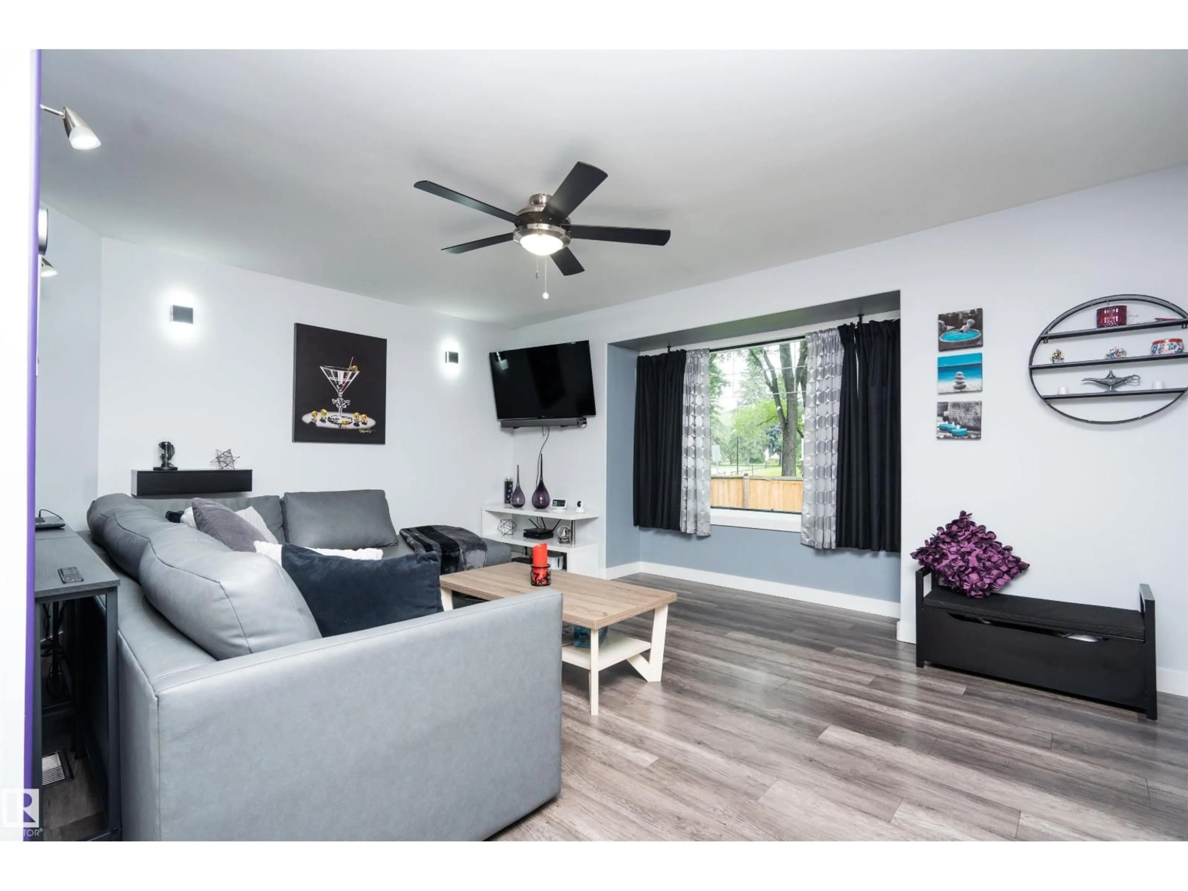 Living room with furniture, wood/laminate floor for 6111 119 AV, Edmonton Alberta T5W1J7