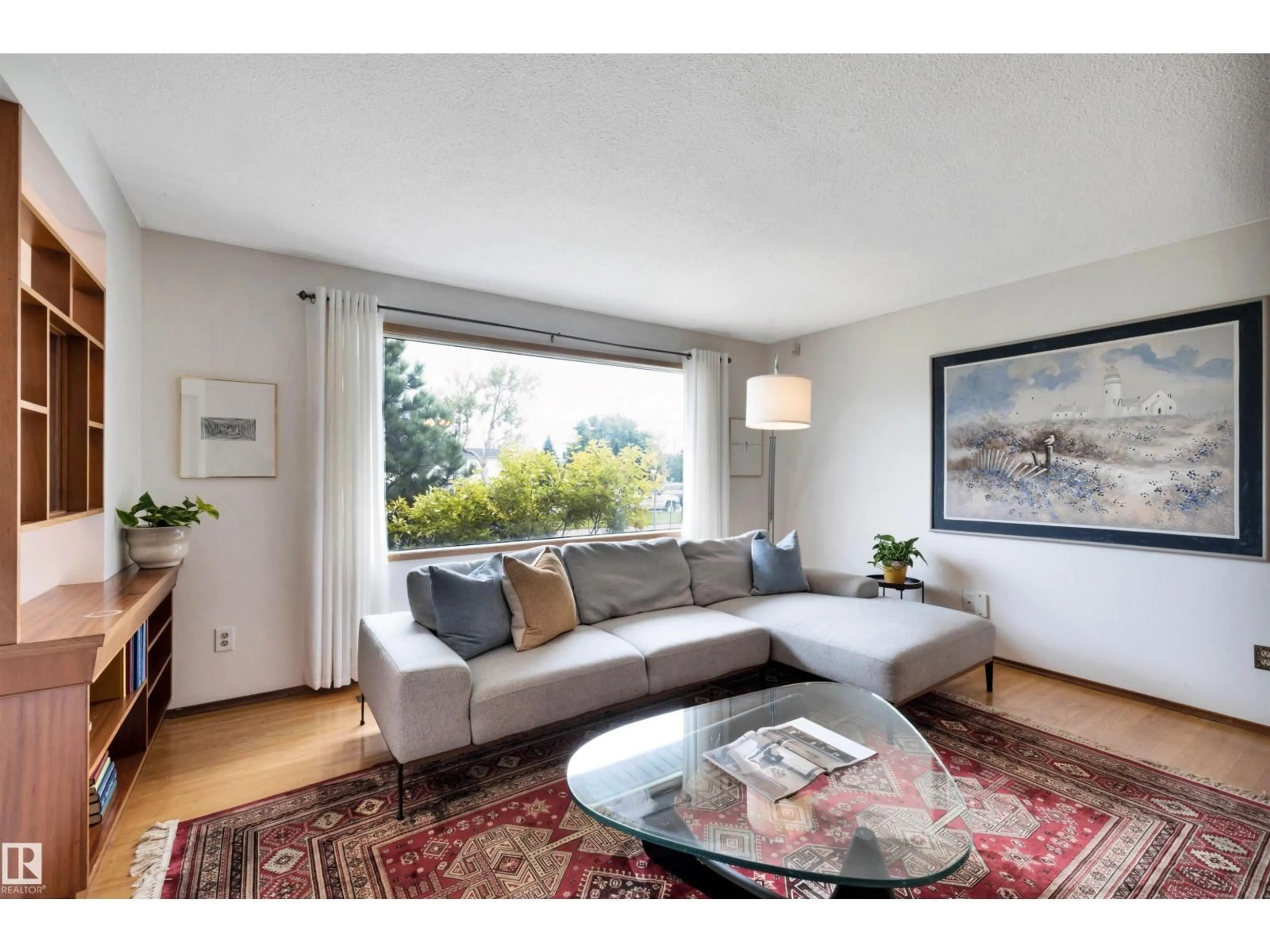 Living room with furniture, wood/laminate floor for NW - 7211 132 AV, Edmonton Alberta T5C3C6