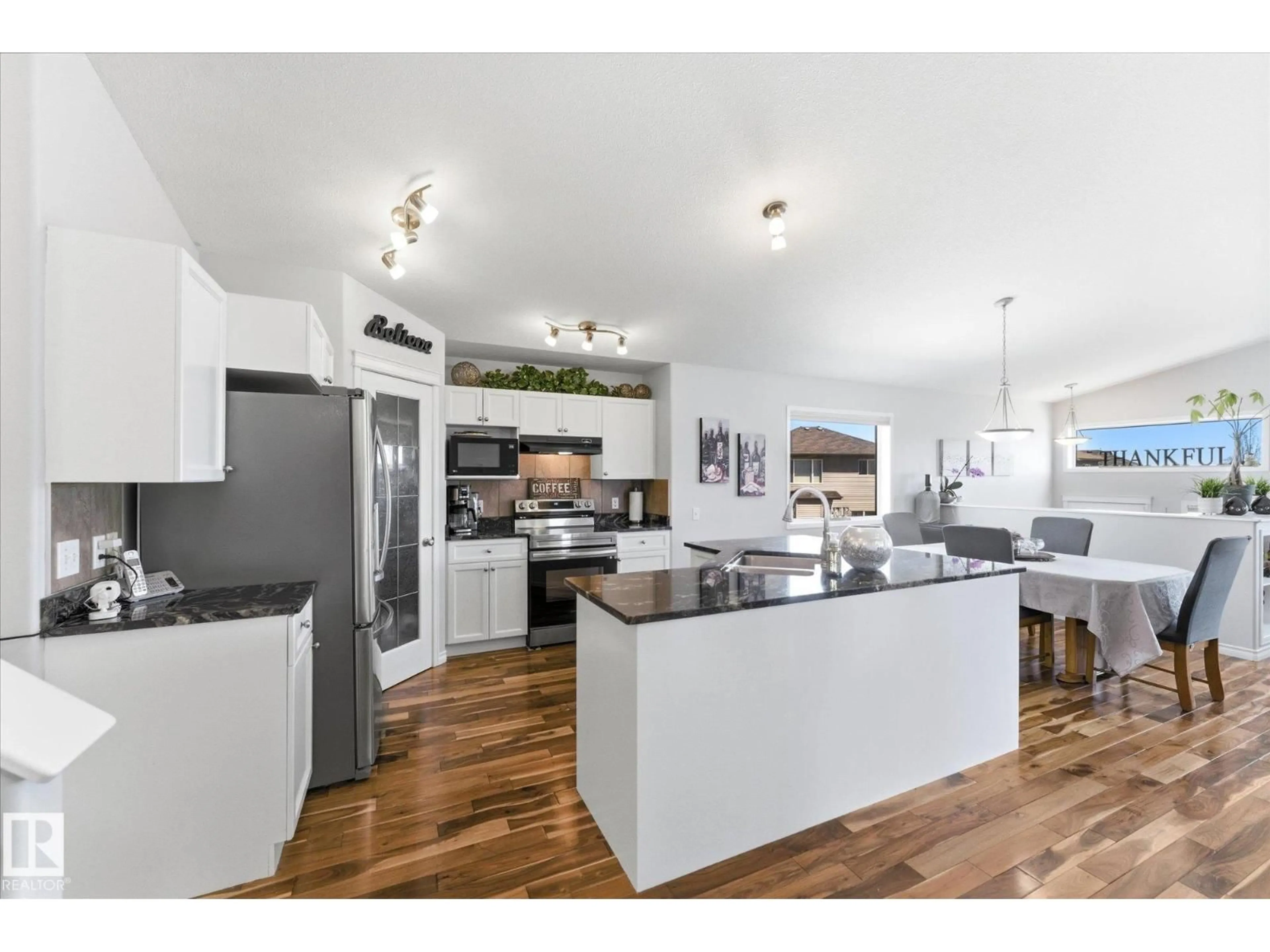 Open concept kitchen, wood/laminate floor for NW - 16303 37 ST, Edmonton Alberta T5Y0H9