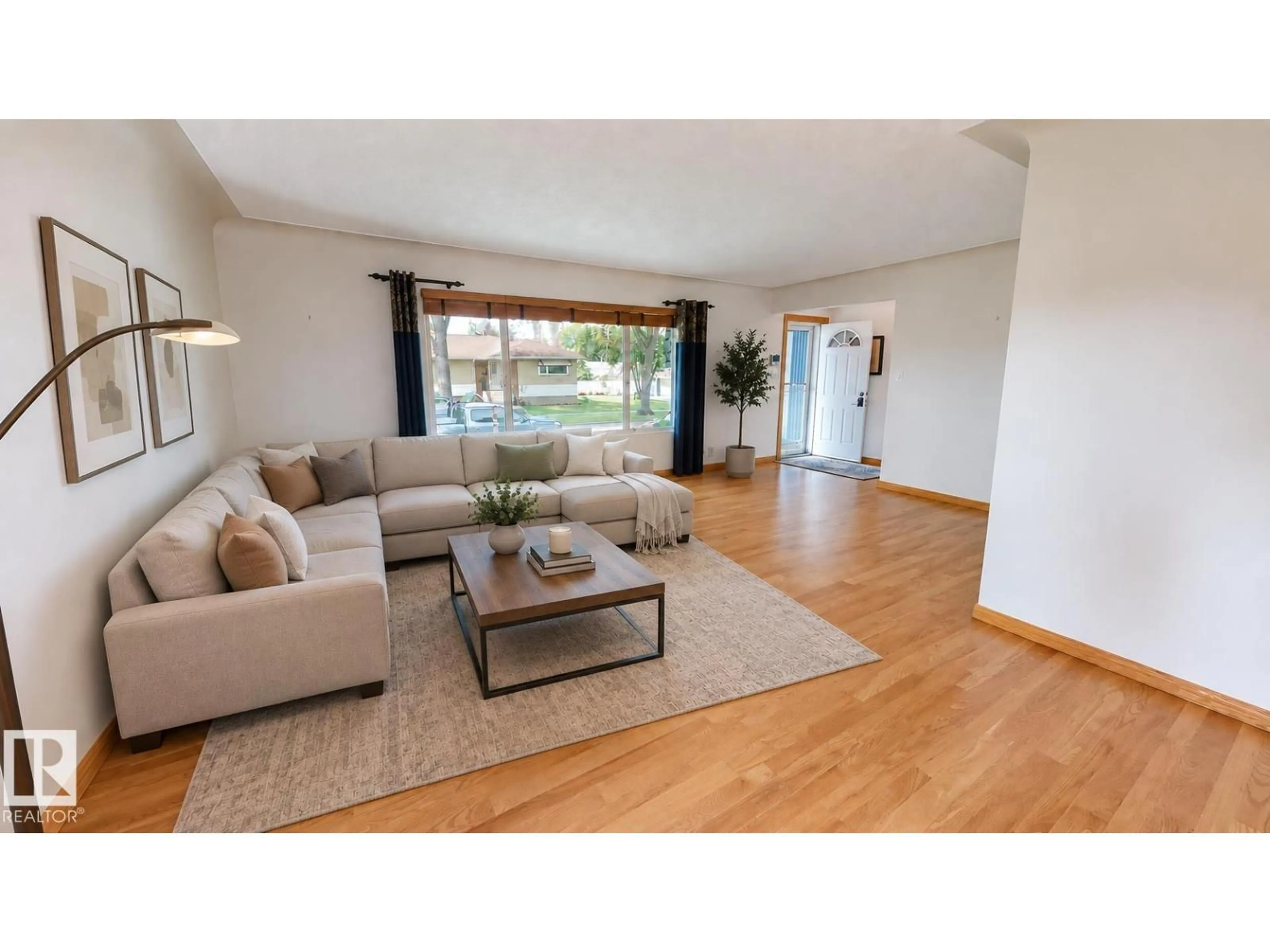 Living room with furniture, wood/laminate floor for 9503 77 ST, Edmonton Alberta T6C2M8