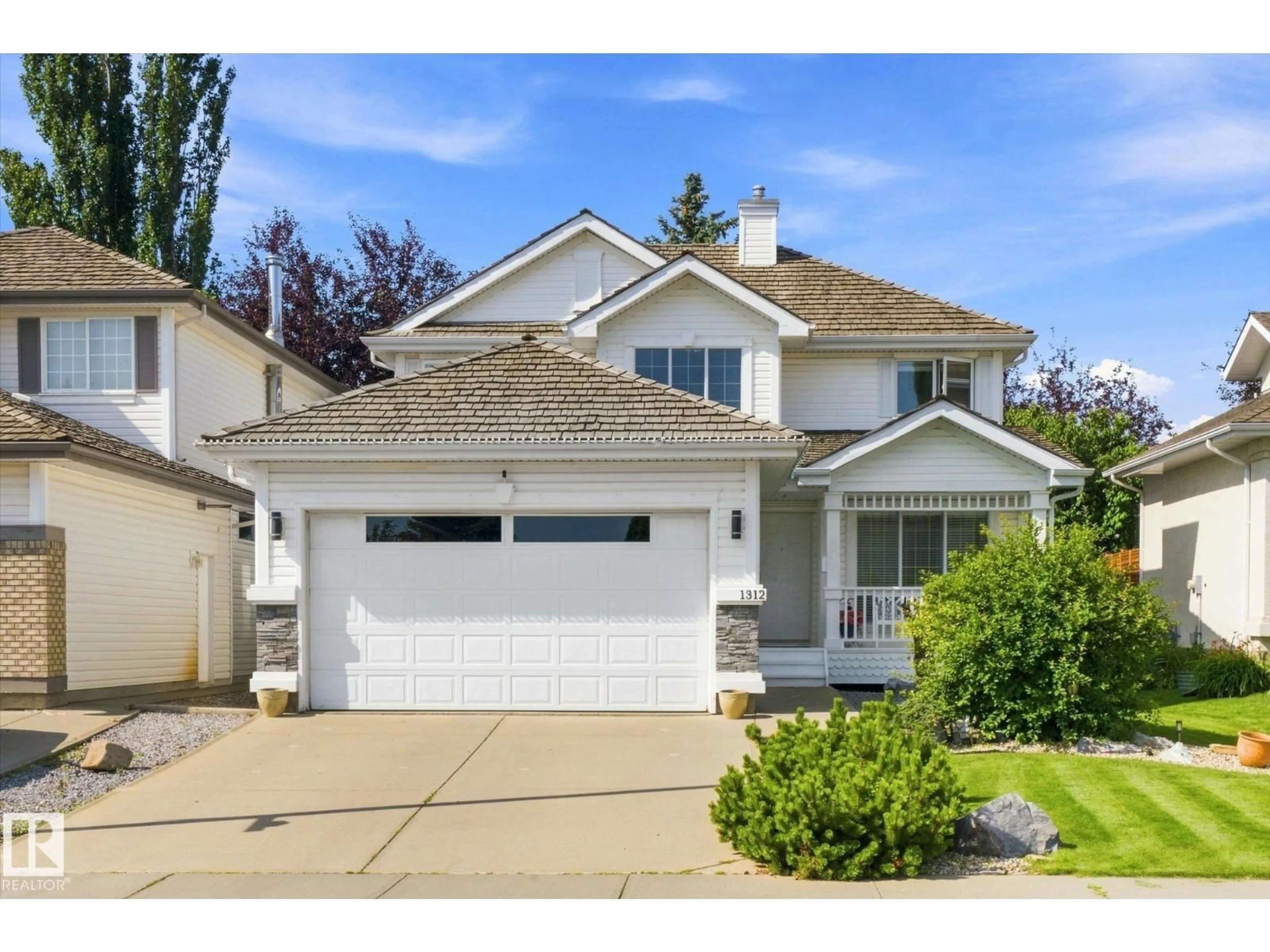 Home with vinyl exterior material, street for 1312 116 ST, Edmonton Alberta T6J7B3