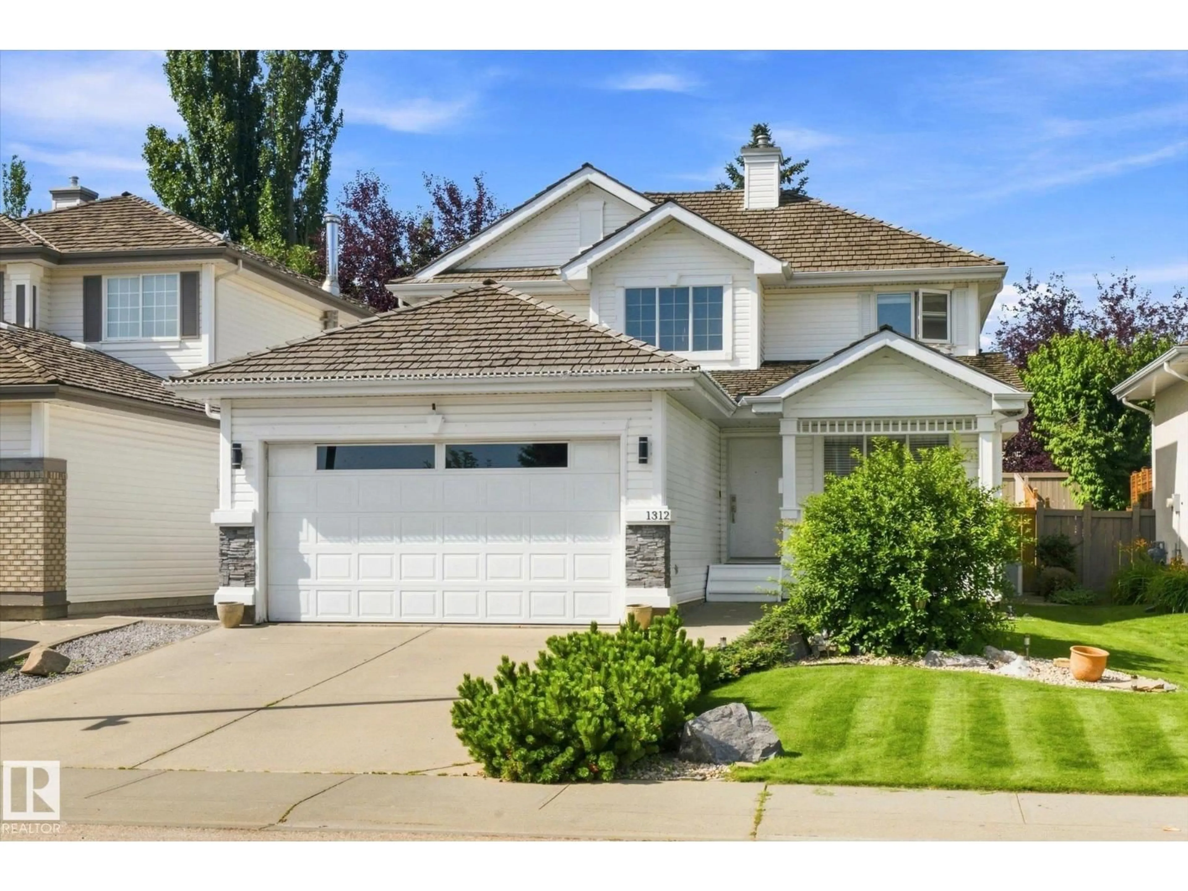 Home with vinyl exterior material, street for 1312 116 ST, Edmonton Alberta T6J7B3