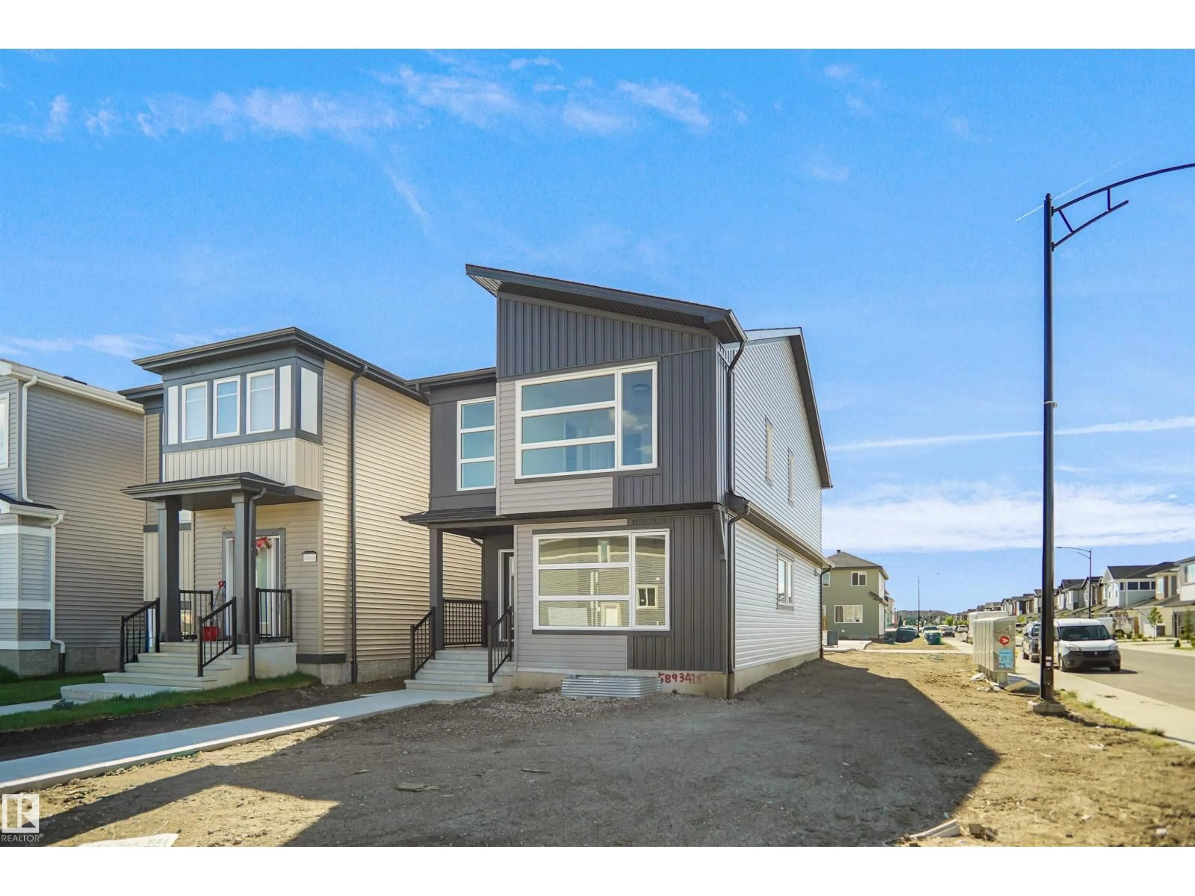 Home with vinyl exterior material, street for 1004 14 AV, Edmonton Alberta T6T2X1