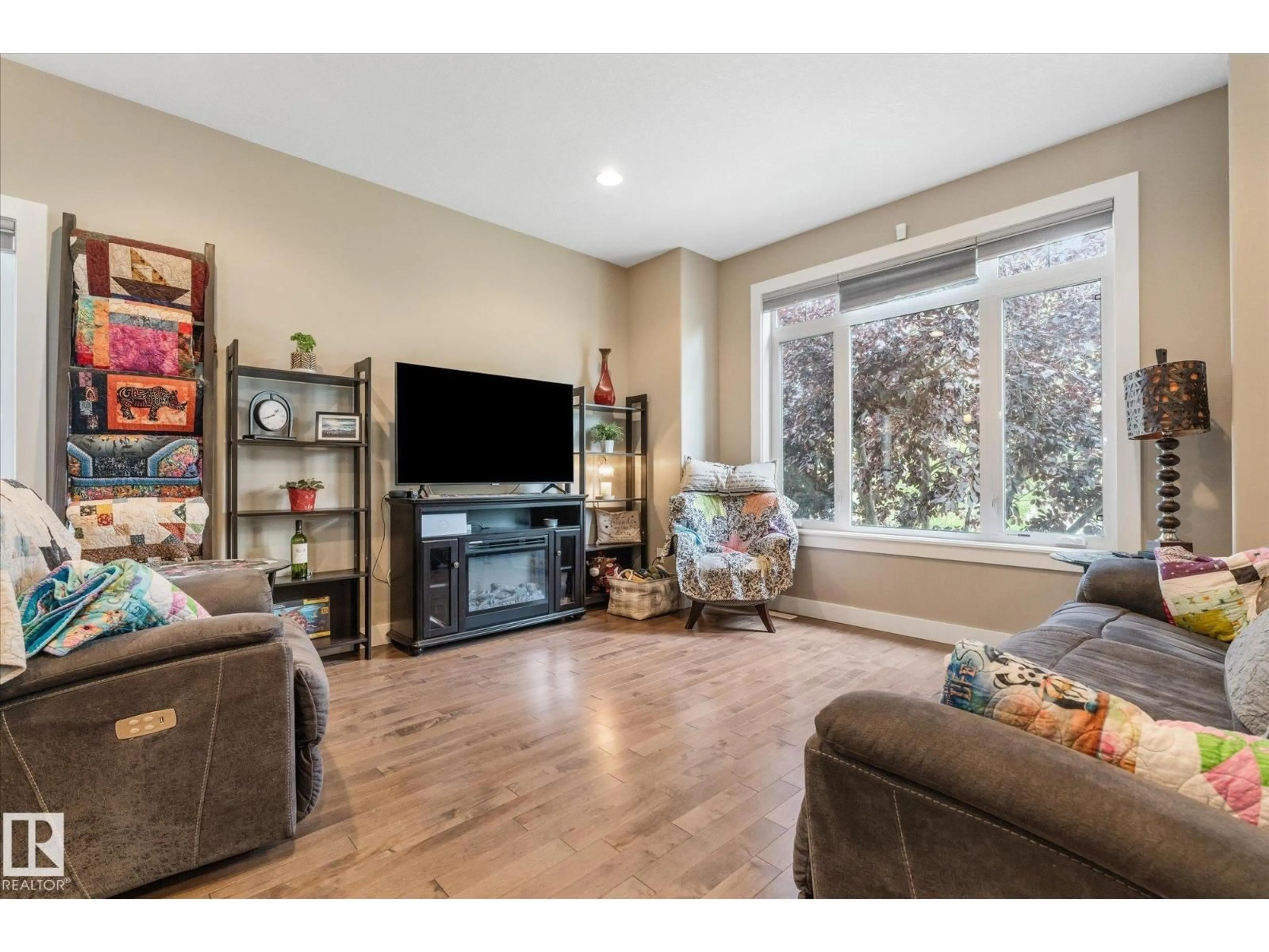 Living room with furniture, wood/laminate floor for 93 DURRAND BN, Fort Saskatchewan Alberta T8L4G8