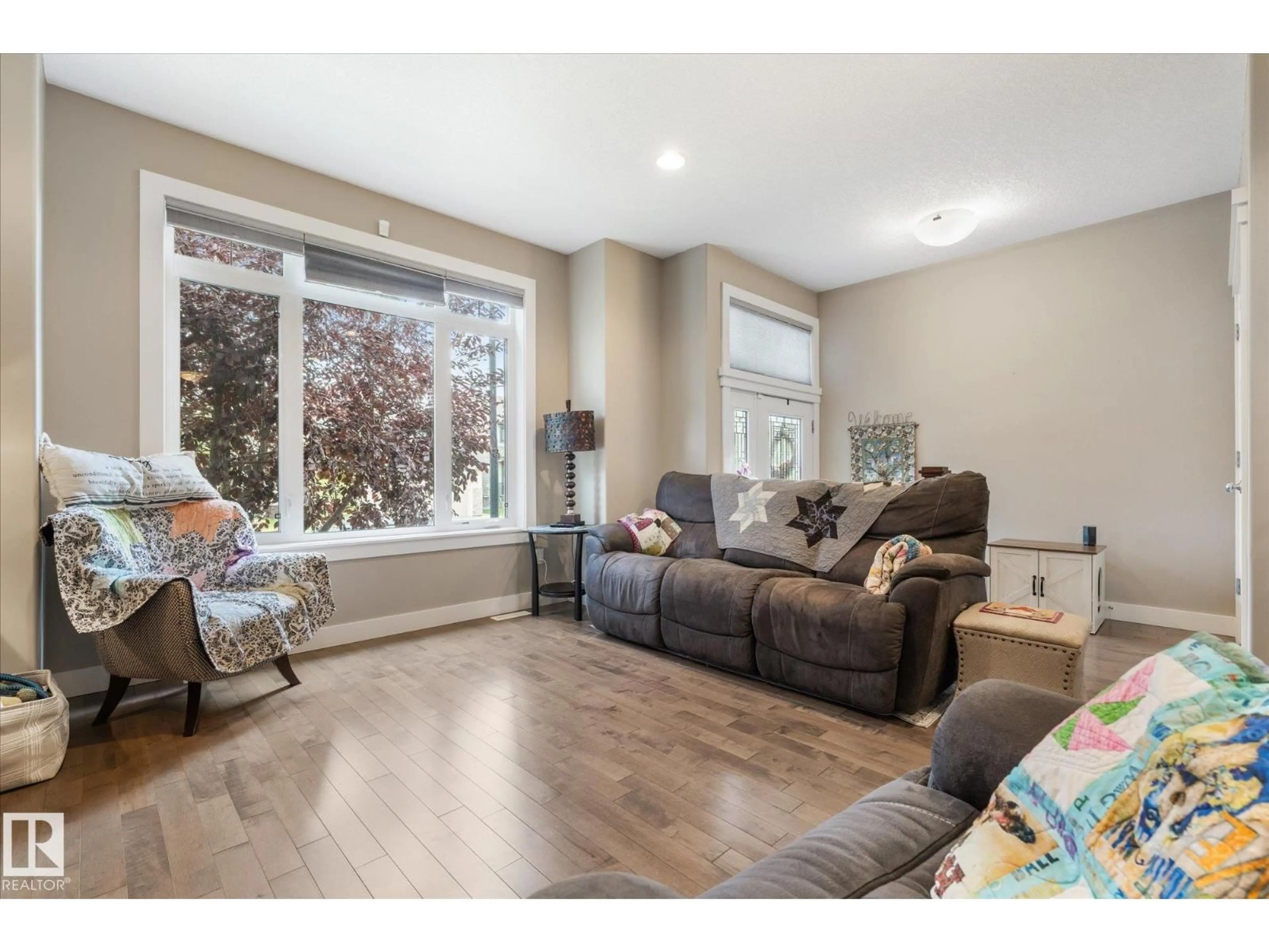 Living room with furniture, wood/laminate floor for 93 DURRAND BN, Fort Saskatchewan Alberta T8L4G8