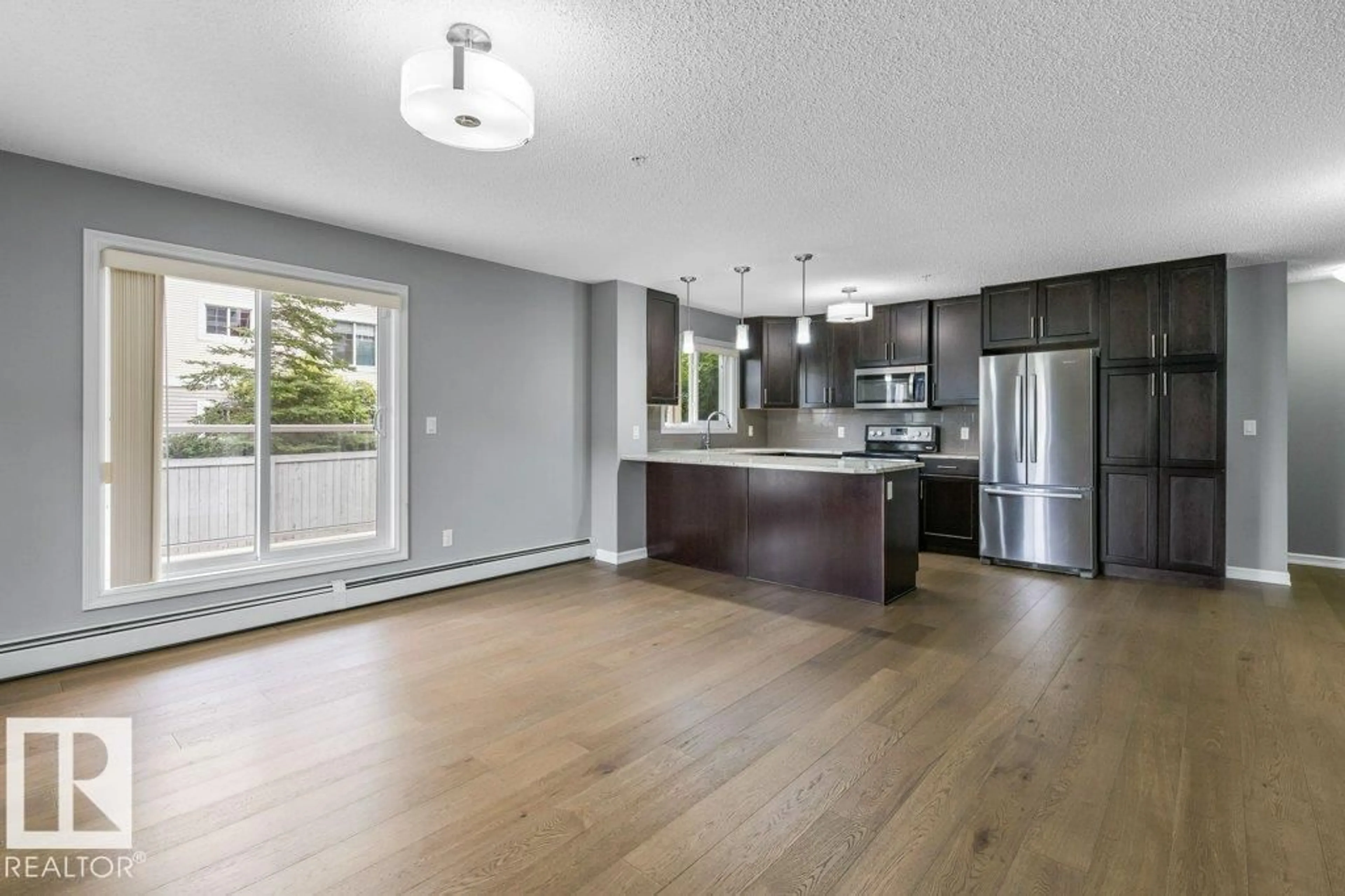Open concept kitchen, wood/laminate floor for 117 - 2203 44 AV, Edmonton Alberta T6T0T1