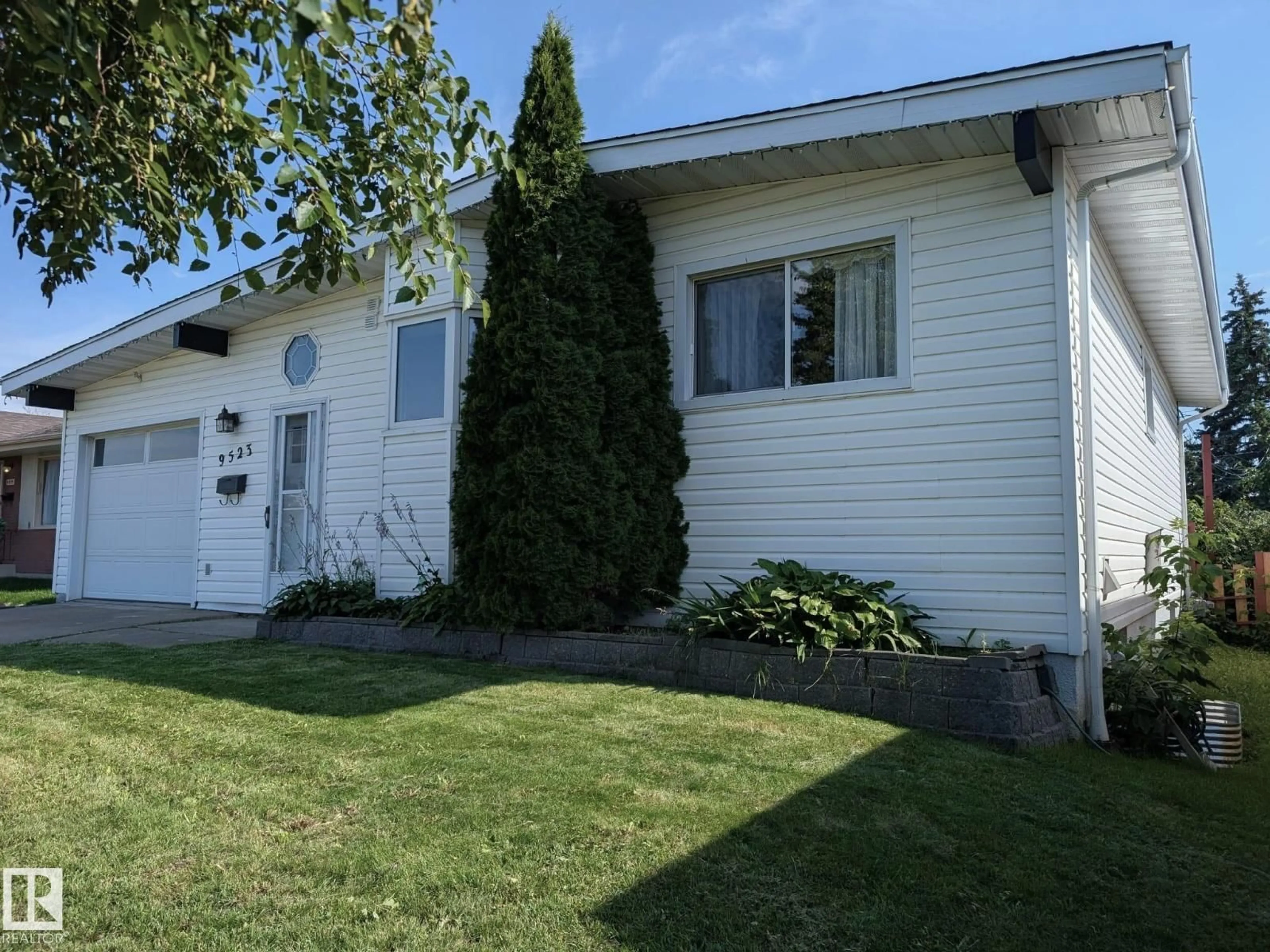 Home with vinyl exterior material, street for 9523 134 AV, Edmonton Alberta T5E1H8