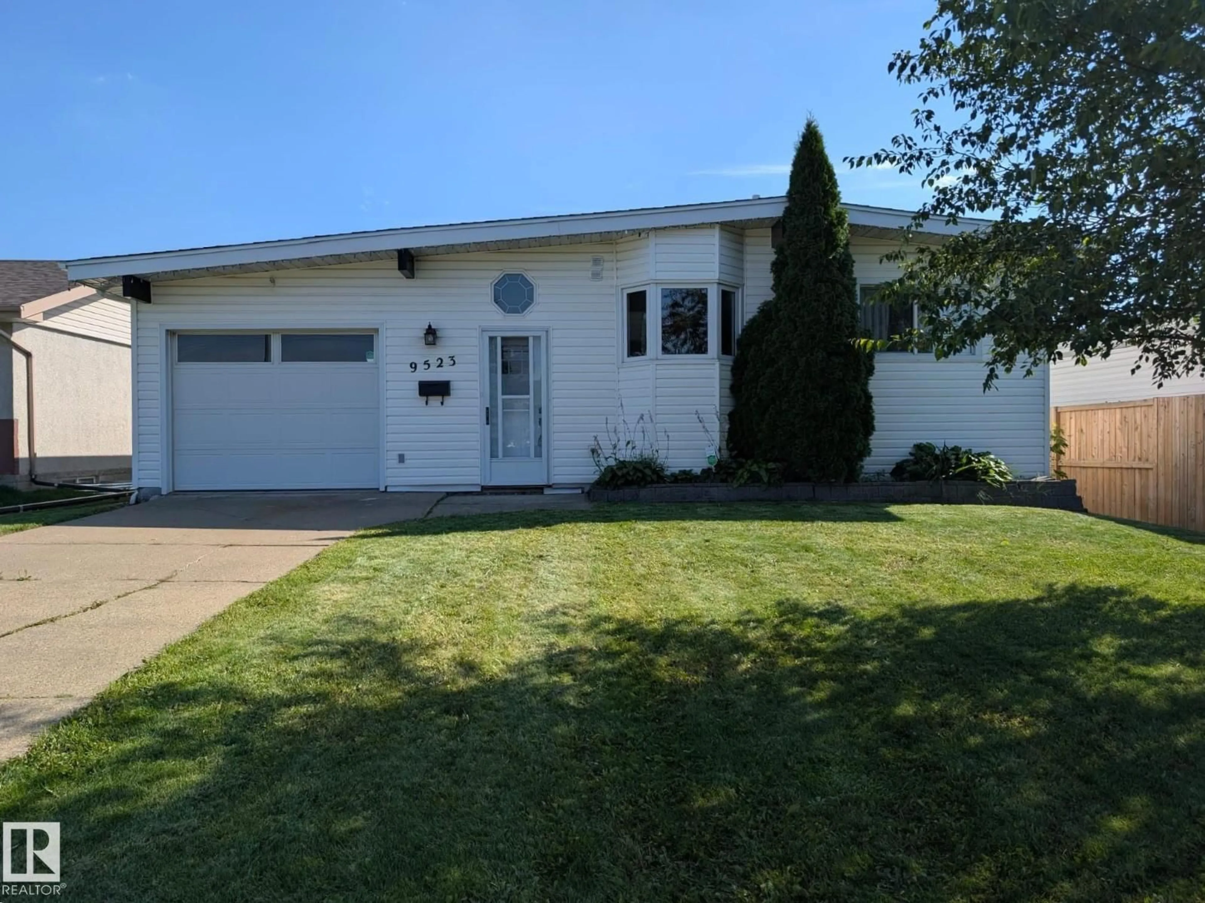 Home with vinyl exterior material, street for 9523 134 AV, Edmonton Alberta T5E1H8