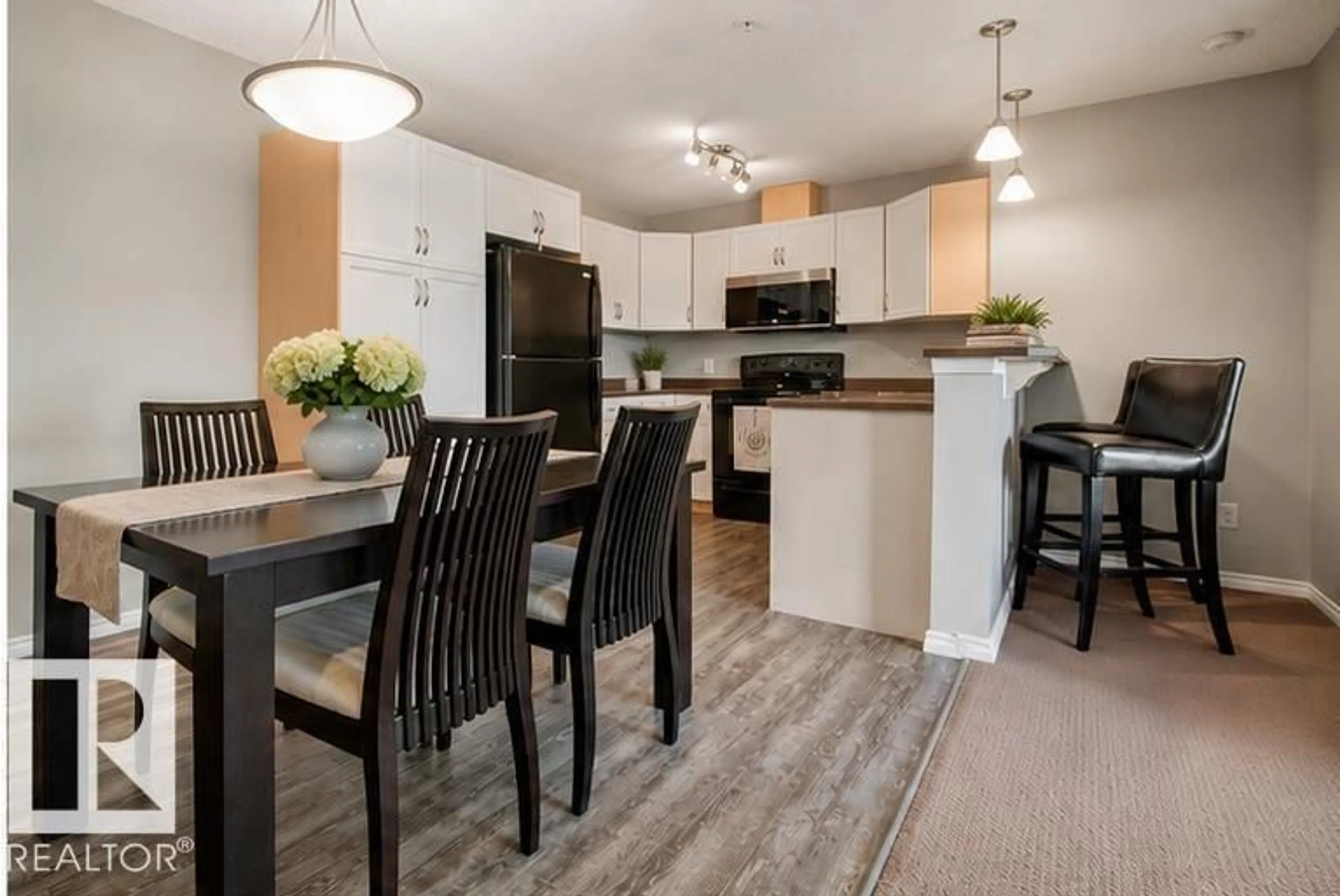 Open concept kitchen, wood/laminate floor for 340 2436 GUARDIAN RD, Edmonton Alberta T5T2P5
