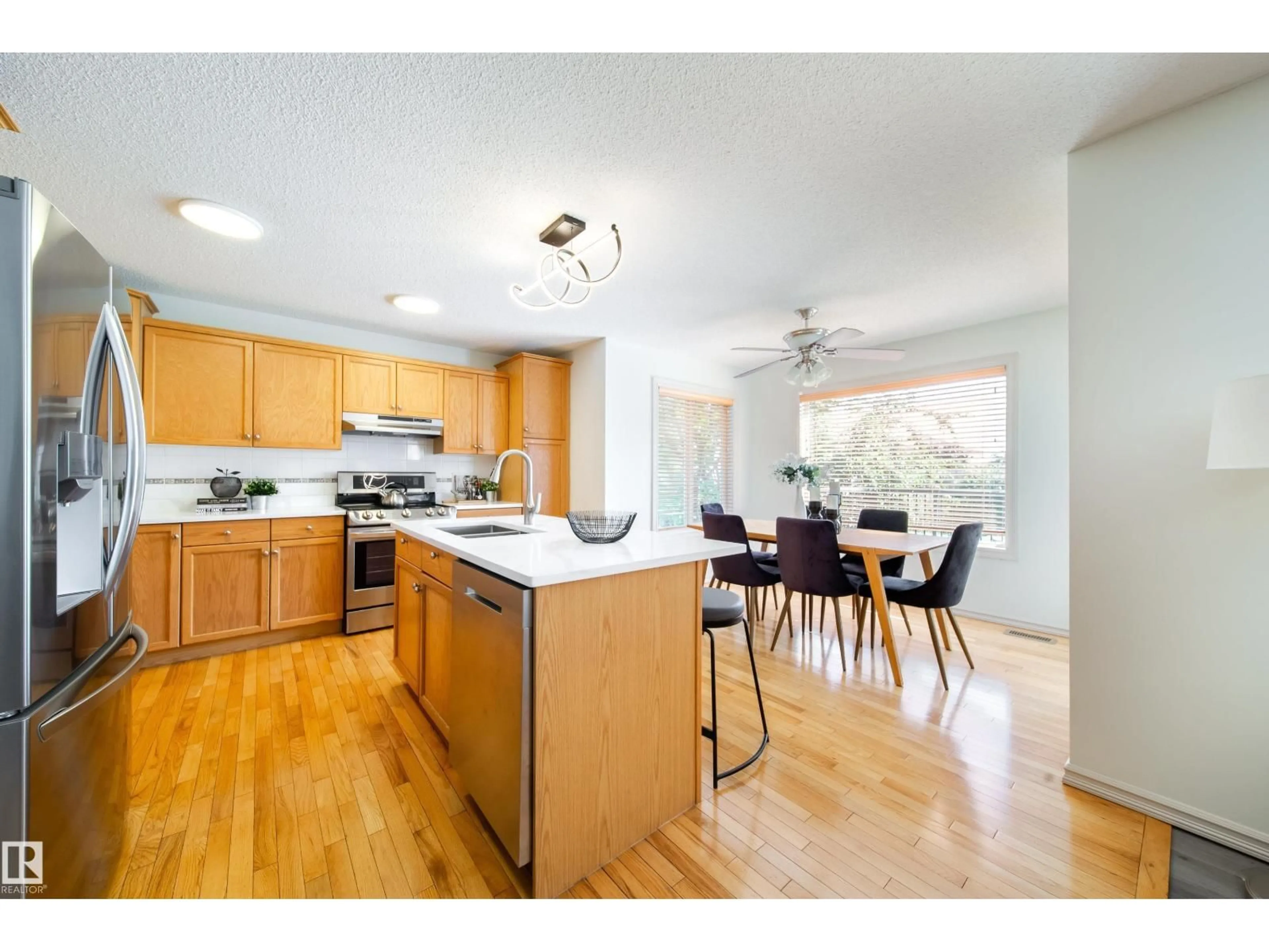 Open concept kitchen, wood/laminate floor for 4811 152 AV, Edmonton Alberta T5Y3B8