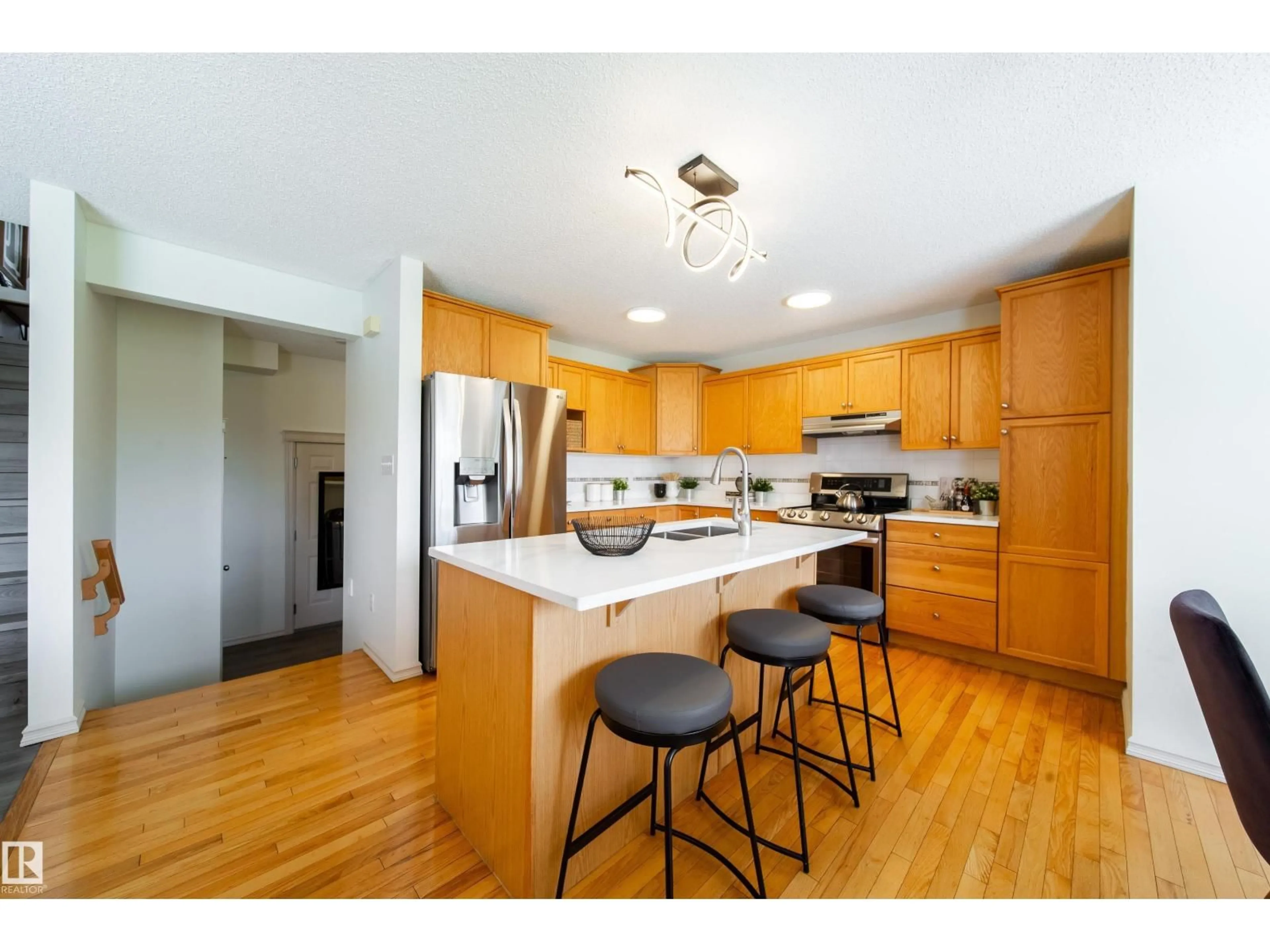 Open concept kitchen, wood/laminate floor for 4811 152 AV, Edmonton Alberta T5Y3B8