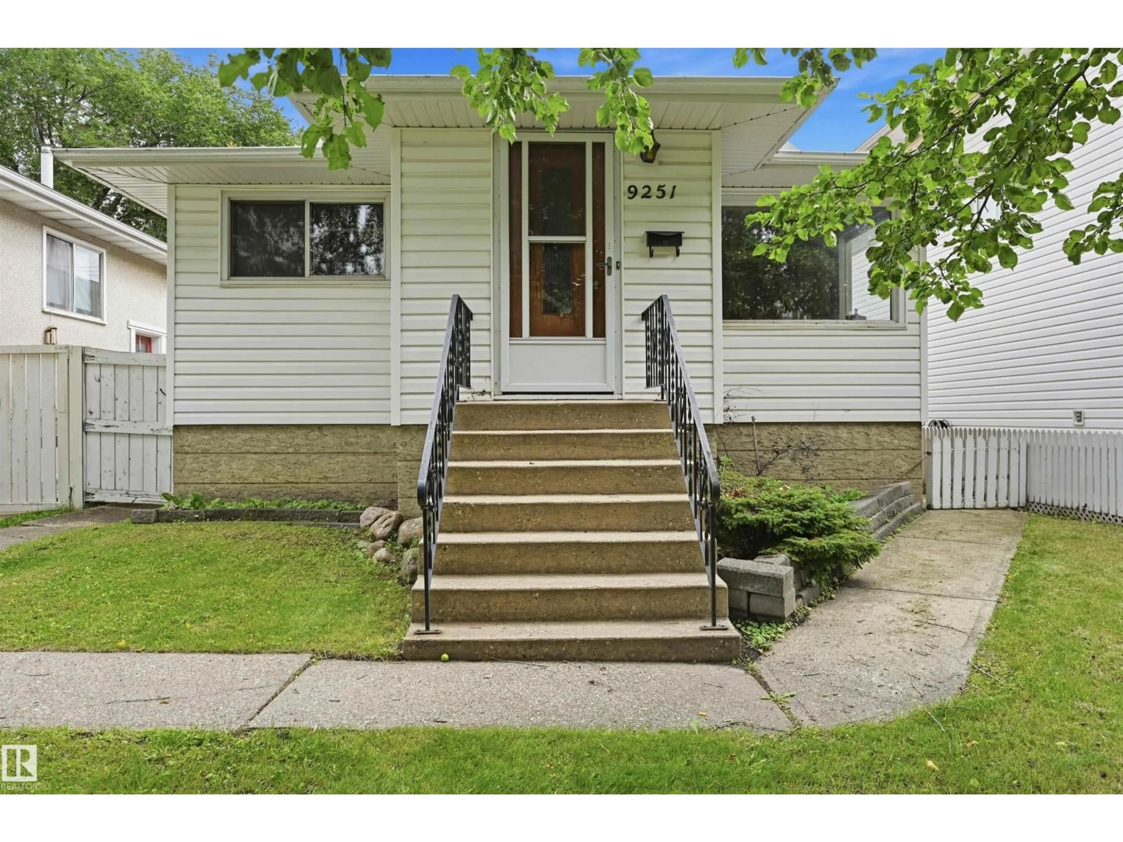 Home with vinyl exterior material, street for NW - 9251 91 ST, Edmonton Alberta T6C3N7
