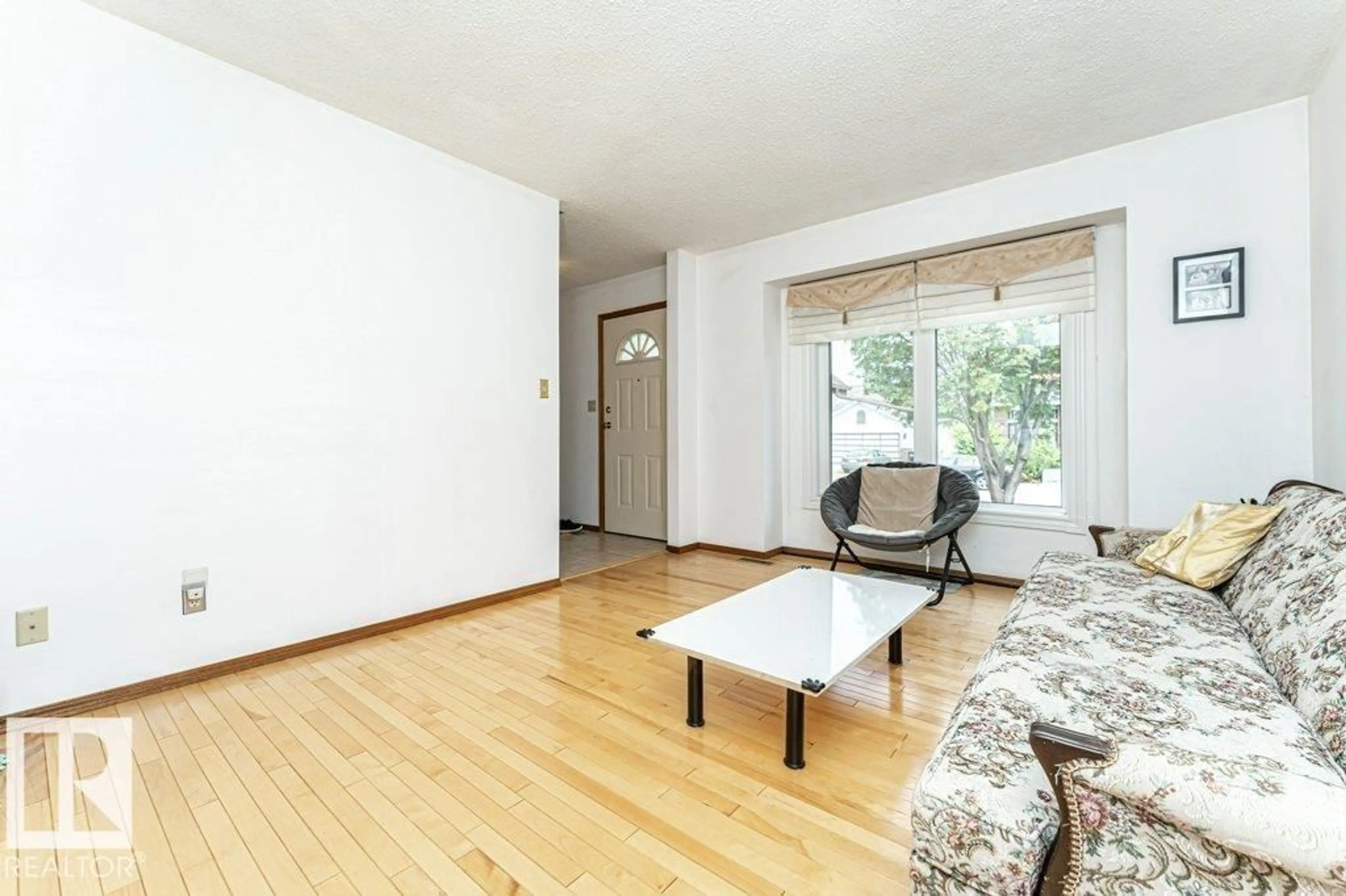 Living room with furniture, wood/laminate floor for 3303 42A AV, Edmonton Alberta T6T1E6