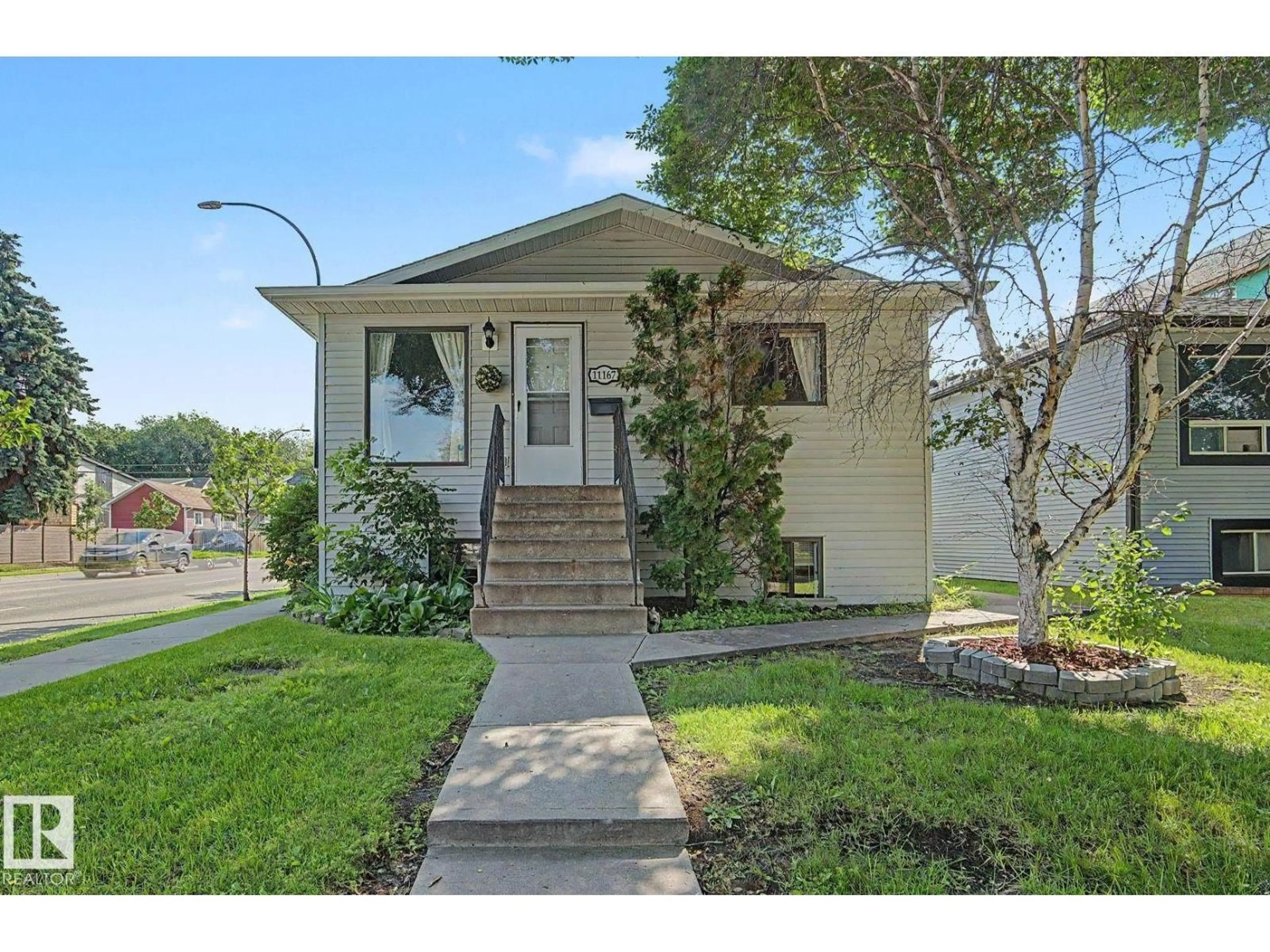 Home with vinyl exterior material, street for NW - 11167 52 ST, Edmonton Alberta T5W3H6