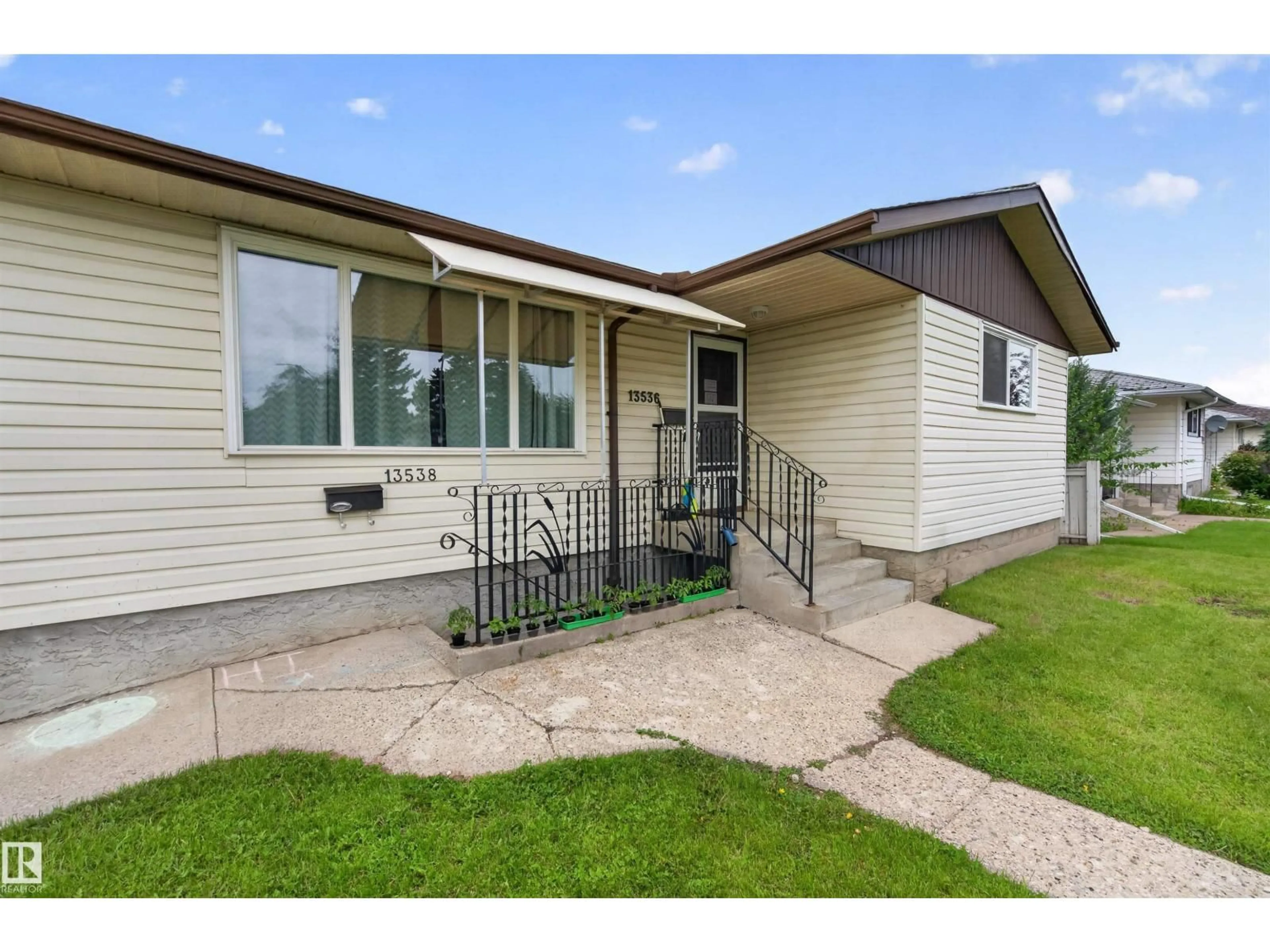 Home with vinyl exterior material, street for 13536 119 ST, Edmonton Alberta T5E5N2