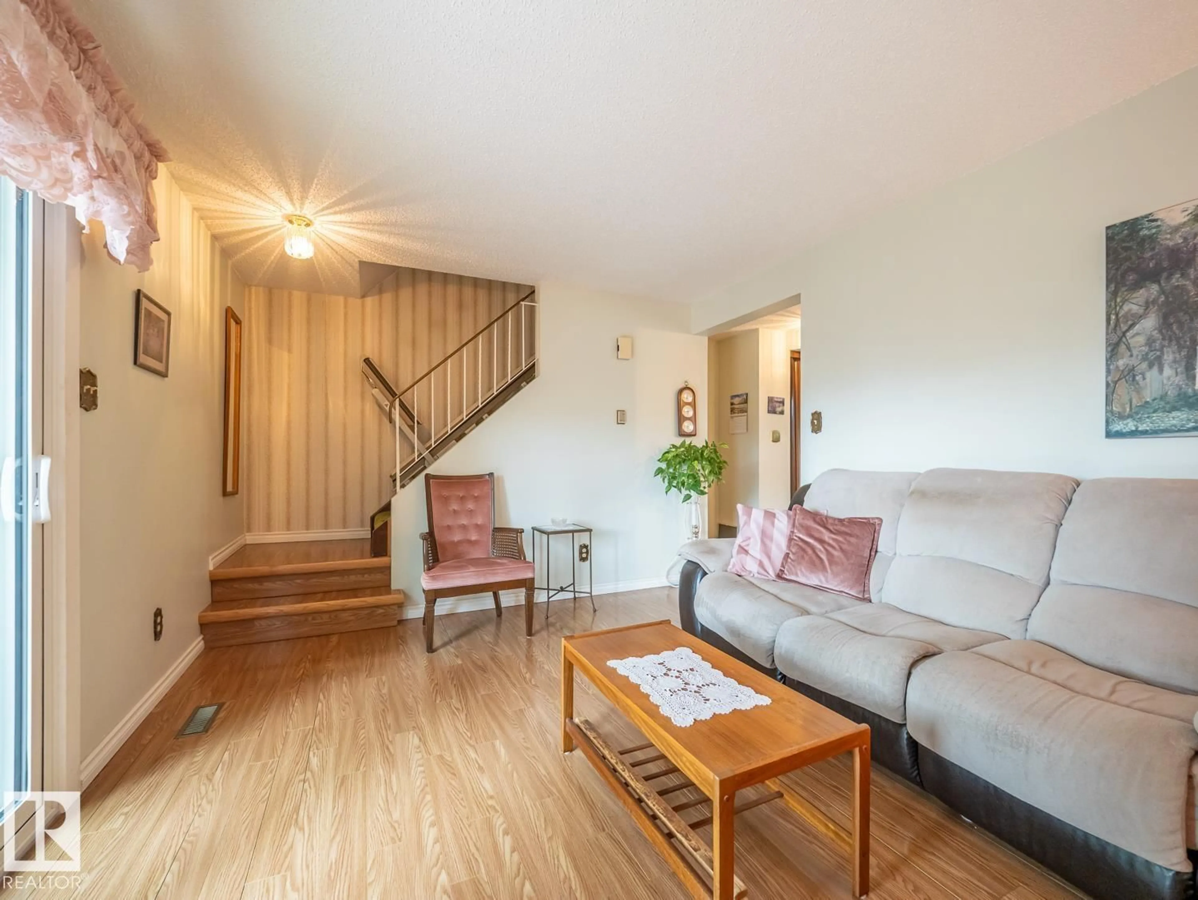 Living room with furniture, wood/laminate floor for 5647 137 AV, Edmonton Alberta T5A2H4