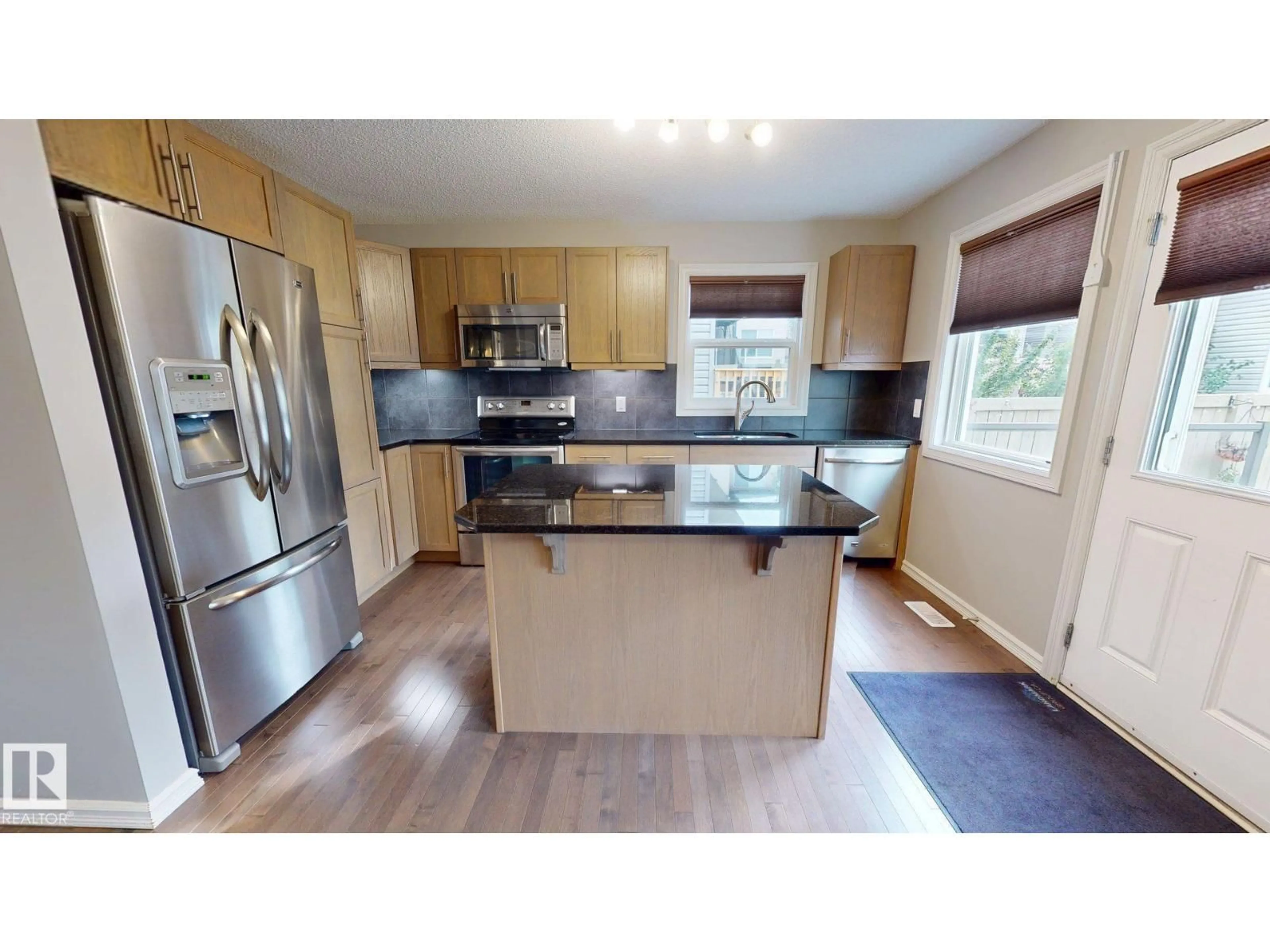 Open concept kitchen, wood/laminate floor for 821 36A AV, Edmonton Alberta T6T0S5