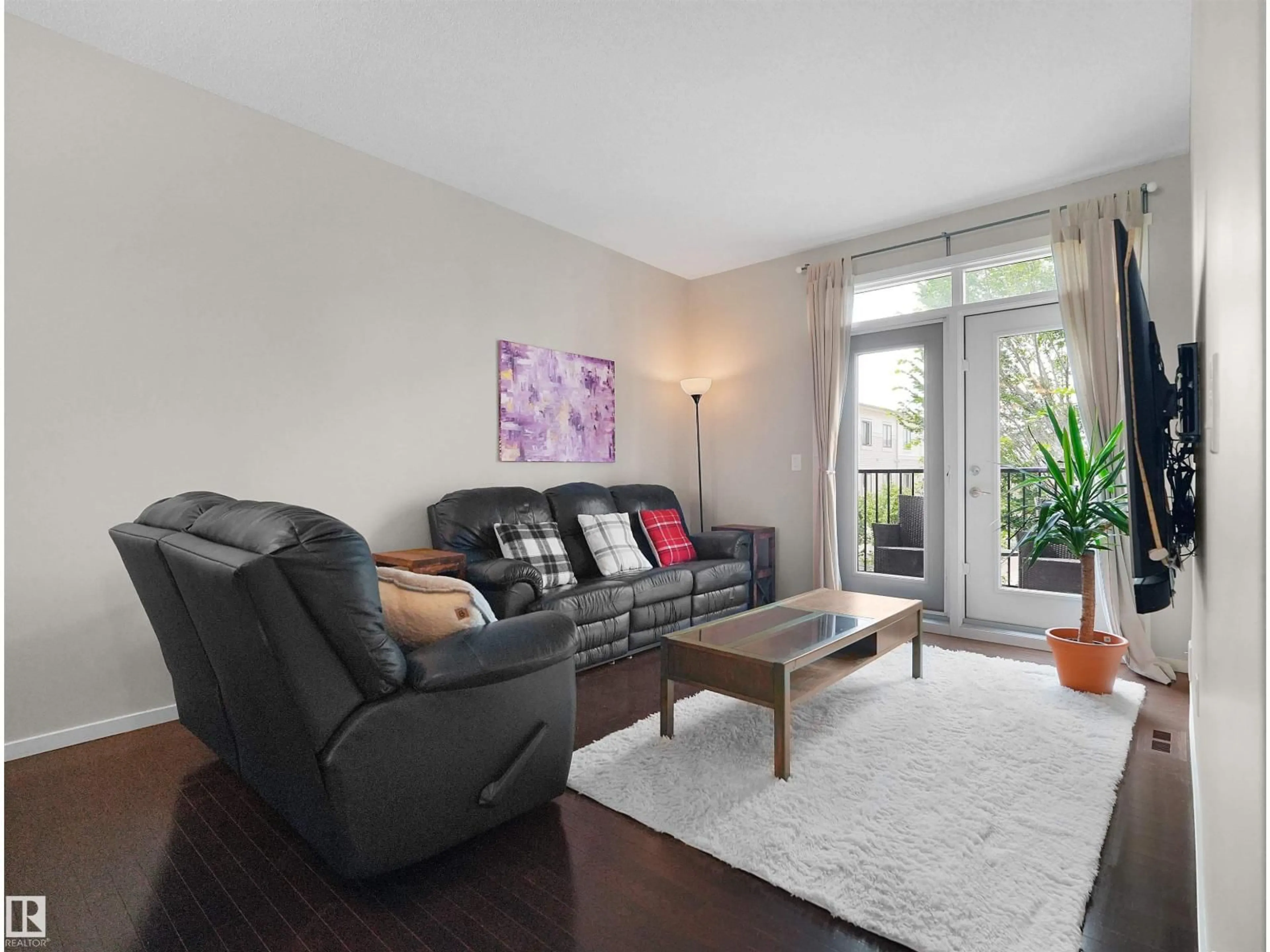 Living room with furniture, wood/laminate floor for 603 - 89 WATT BV, Edmonton Alberta T6X0P3
