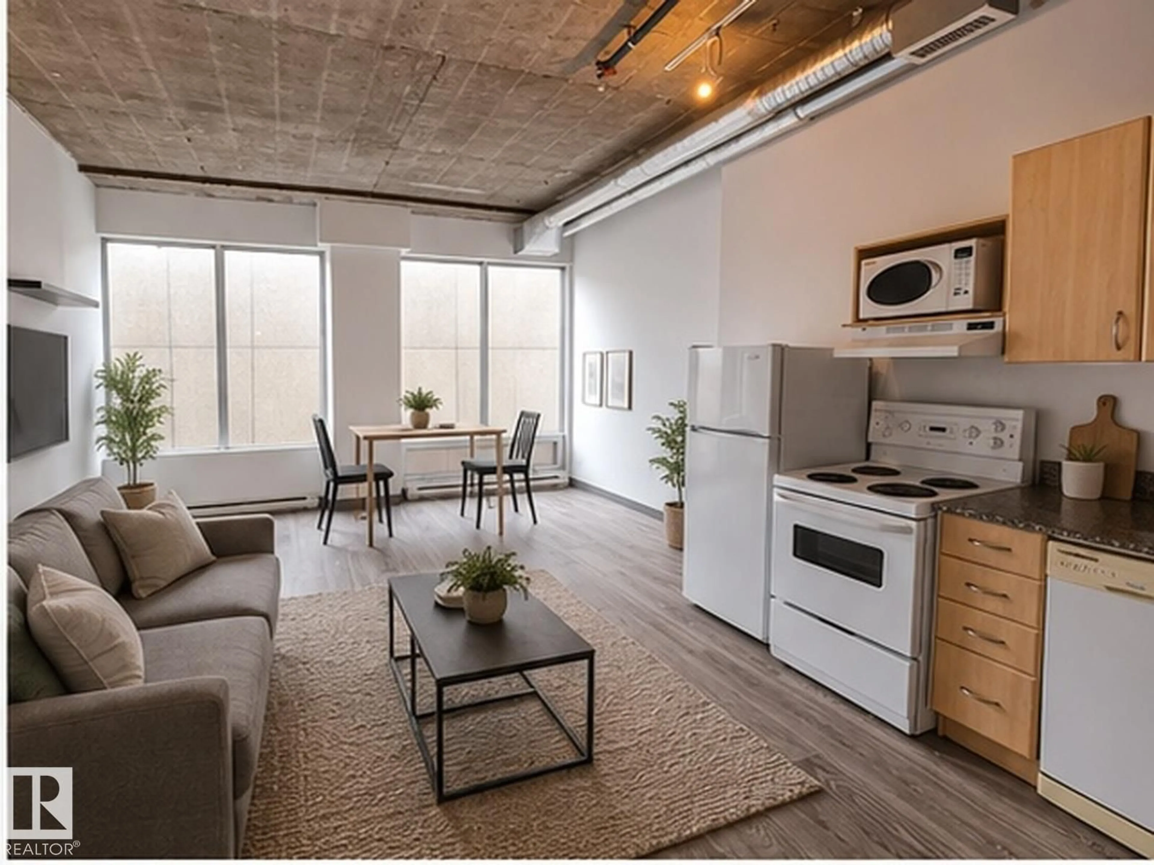 Living room with furniture, cement floor for #807 - 10024 JASPER AV, Edmonton Alberta T5J1R9