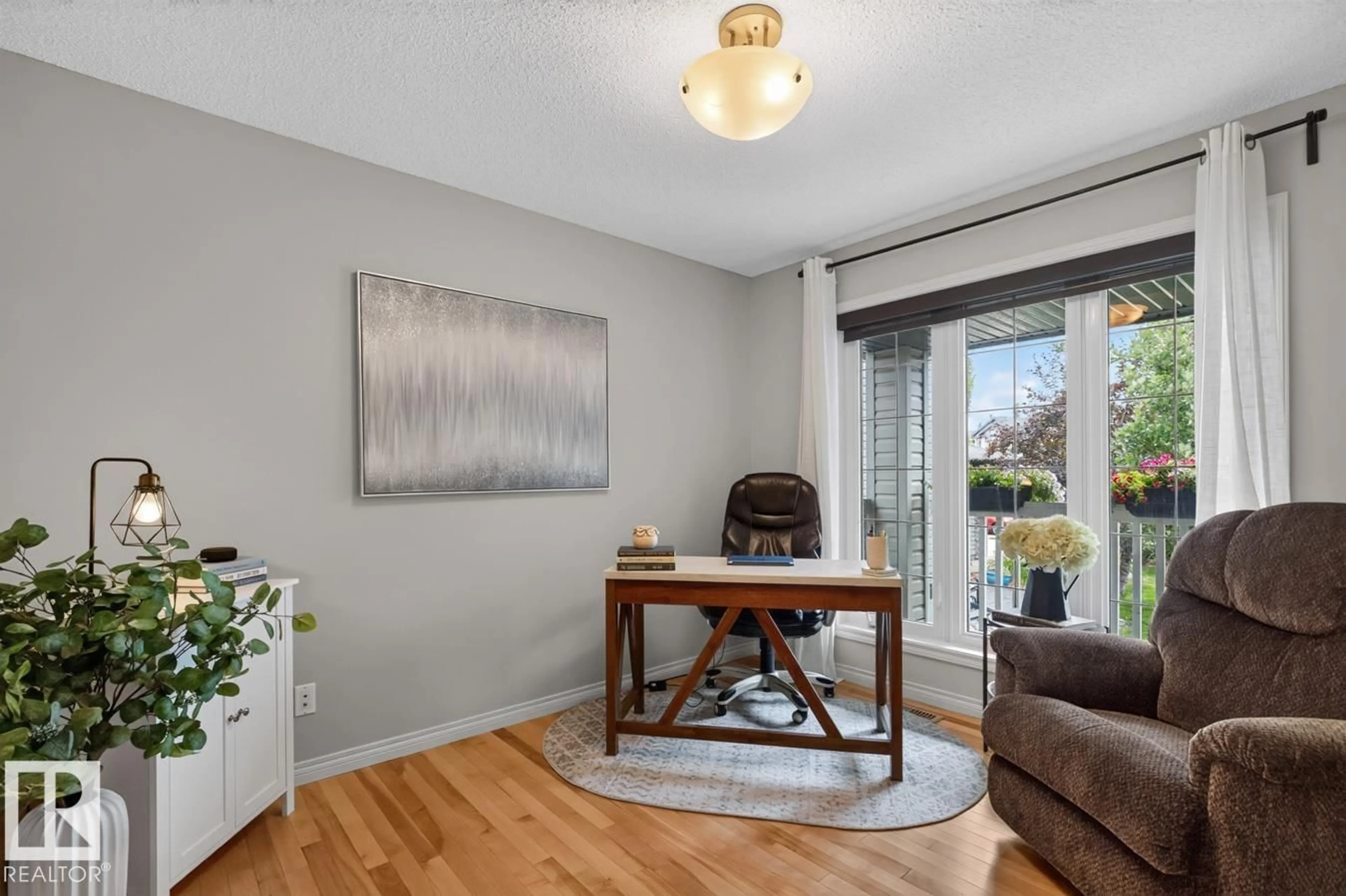 Living room with furniture, wood/laminate floor for 627 FOXTAIL LN, Sherwood Park Alberta T8A4P2
