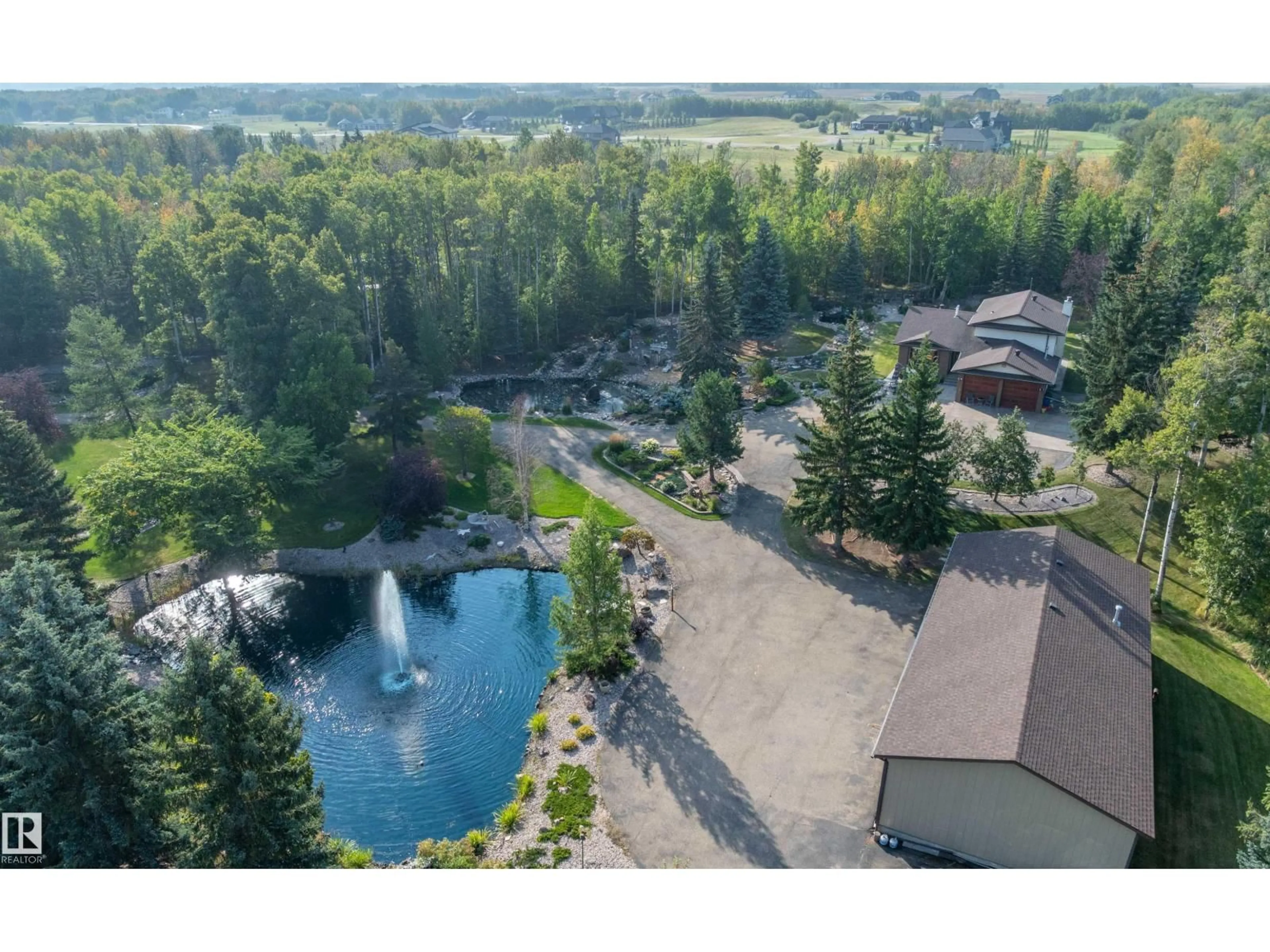 A pic from outside/outdoor area/front of a property/back of a property/a pic from drone, water/lake/river/ocean view for 170 - 50470 RANGE ROAD 234, Rural Leduc County Alberta T4X0L7