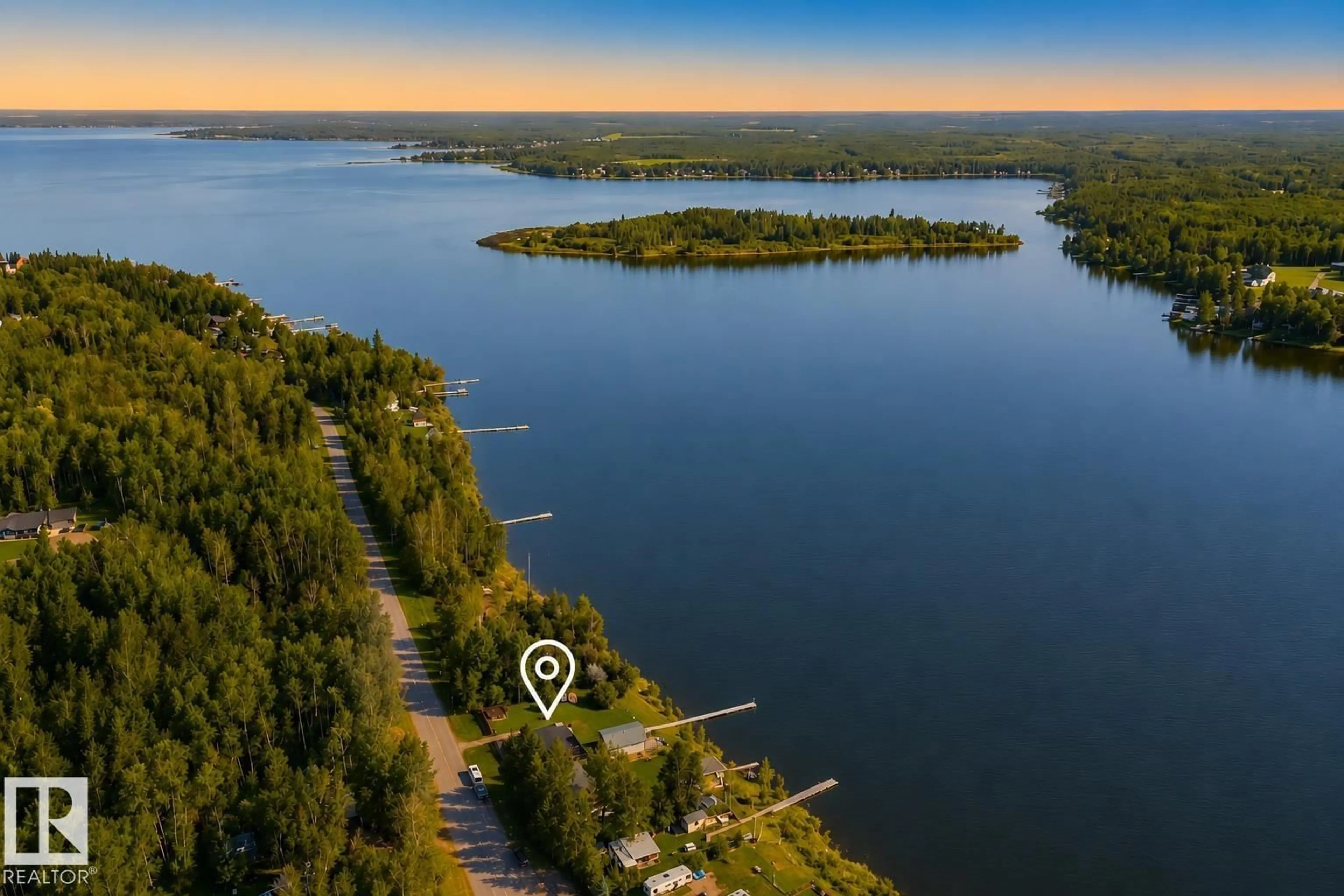 A pic from outside/outdoor area/front of a property/back of a property/a pic from drone, water/lake/river/ocean view for 264 BEACH AV, Rural Barrhead County Alberta T0E1V0