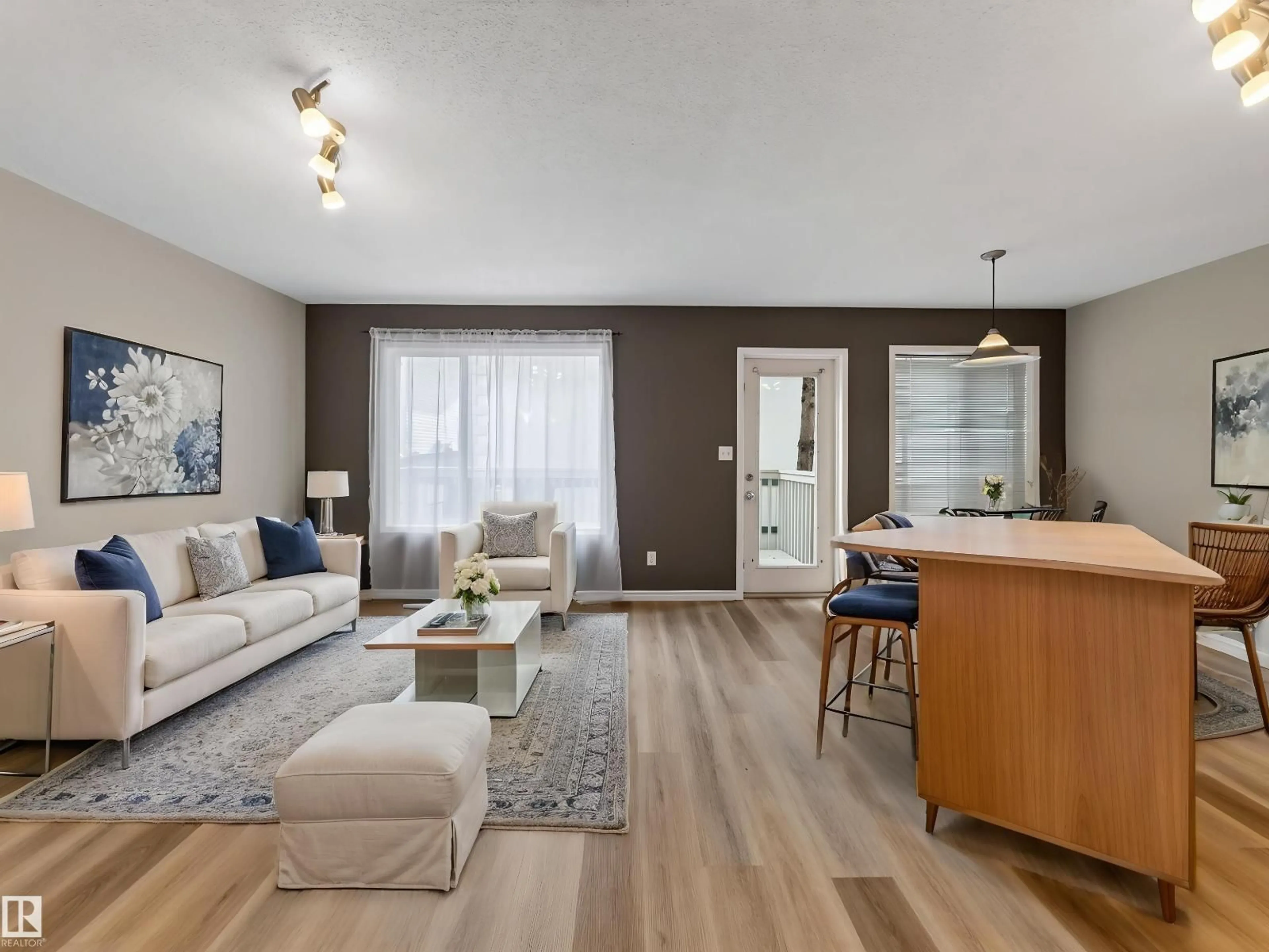 Living room with furniture, wood/laminate floor for NW - 13003 101 ST, Edmonton Alberta T5E4G1