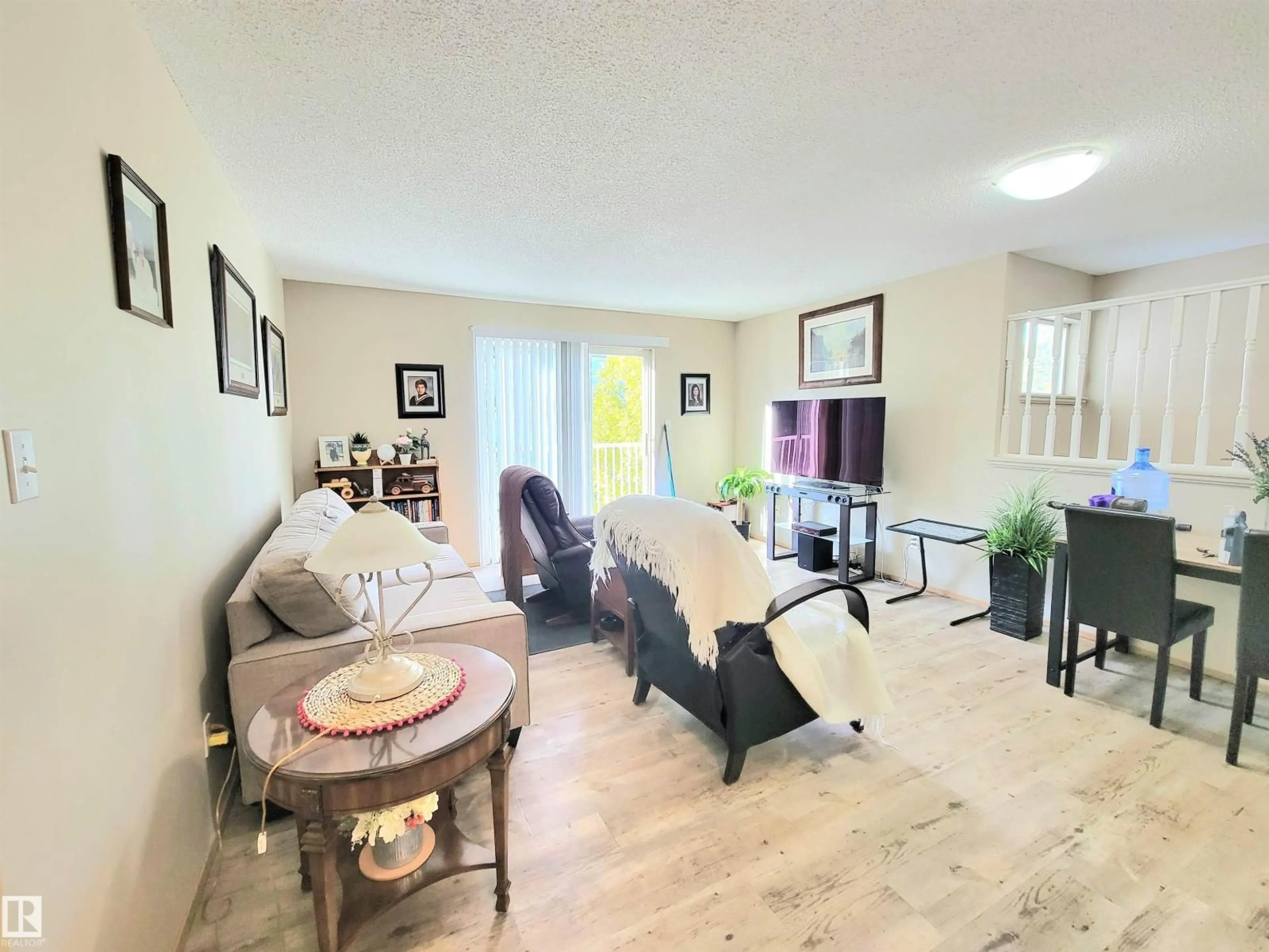 Living room with furniture, wood/laminate floor for #108D - 122 WESTPARK DR, Fort Saskatchewan Alberta T8L4M2
