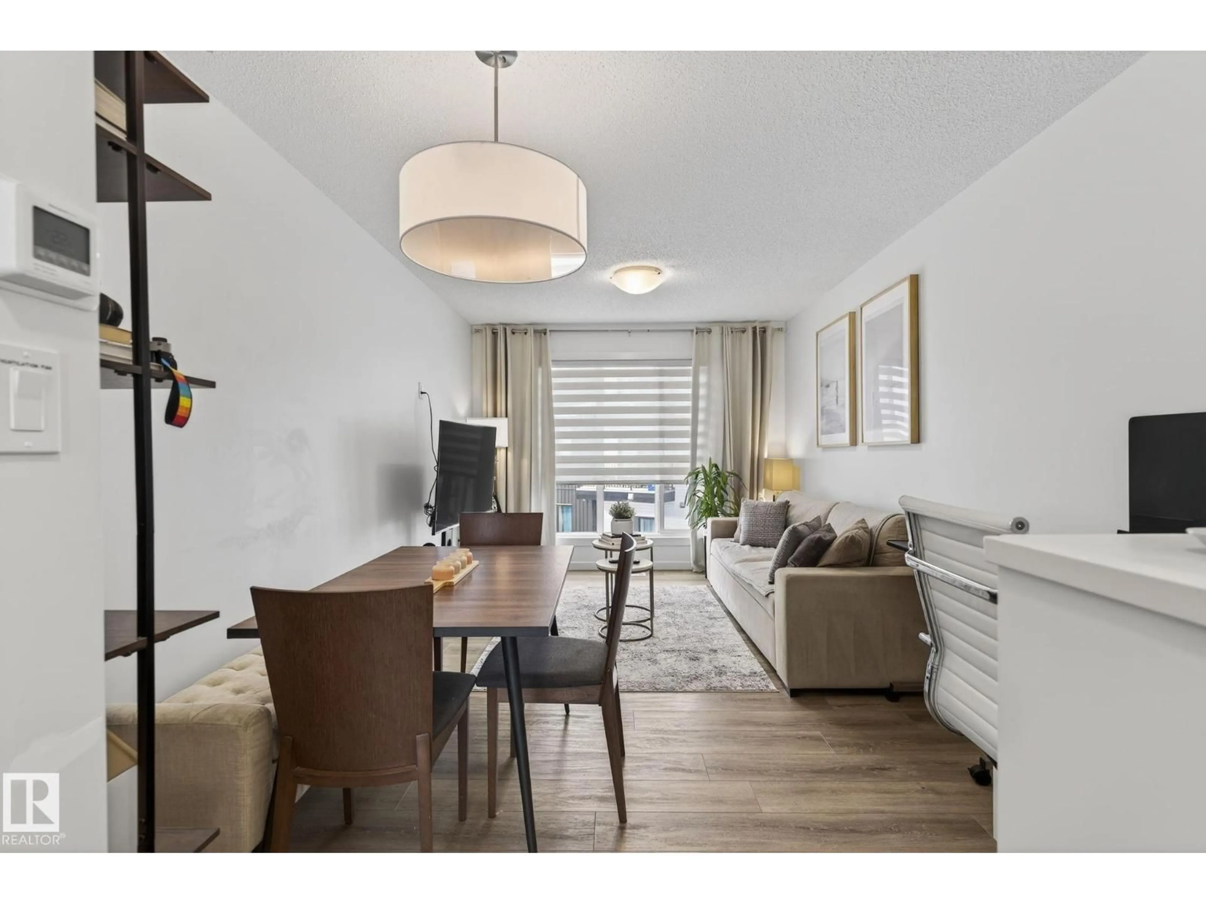 Living room with furniture, wood/laminate floor for 850 - 46 SECORD BV, Edmonton Alberta T5T7R9