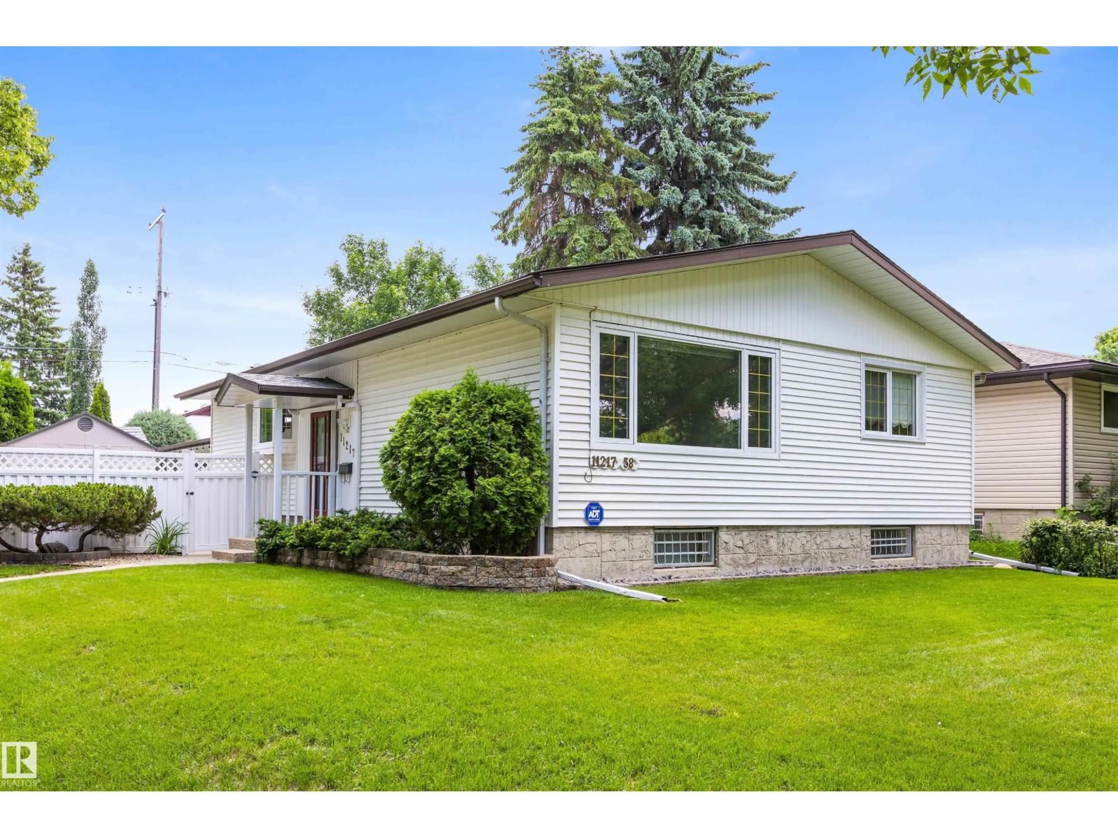 Home with vinyl exterior material, street for NW - 11217 38 ST, Edmonton Alberta T5W2G3