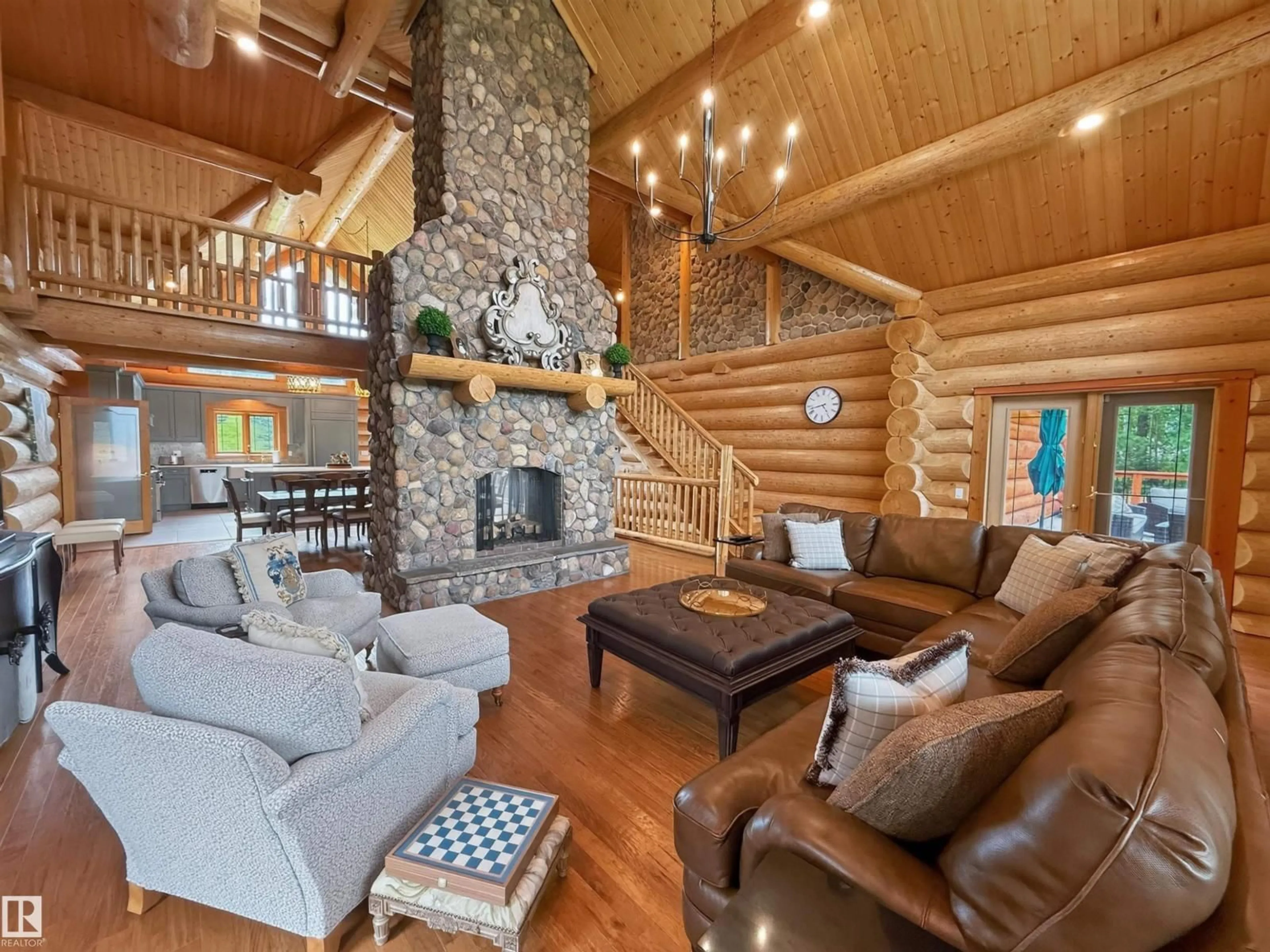 Living room with furniture, wood/laminate floor for 52111 - 16 RGE ROAD 25, Rural Parkland County Alberta T7Y2M4